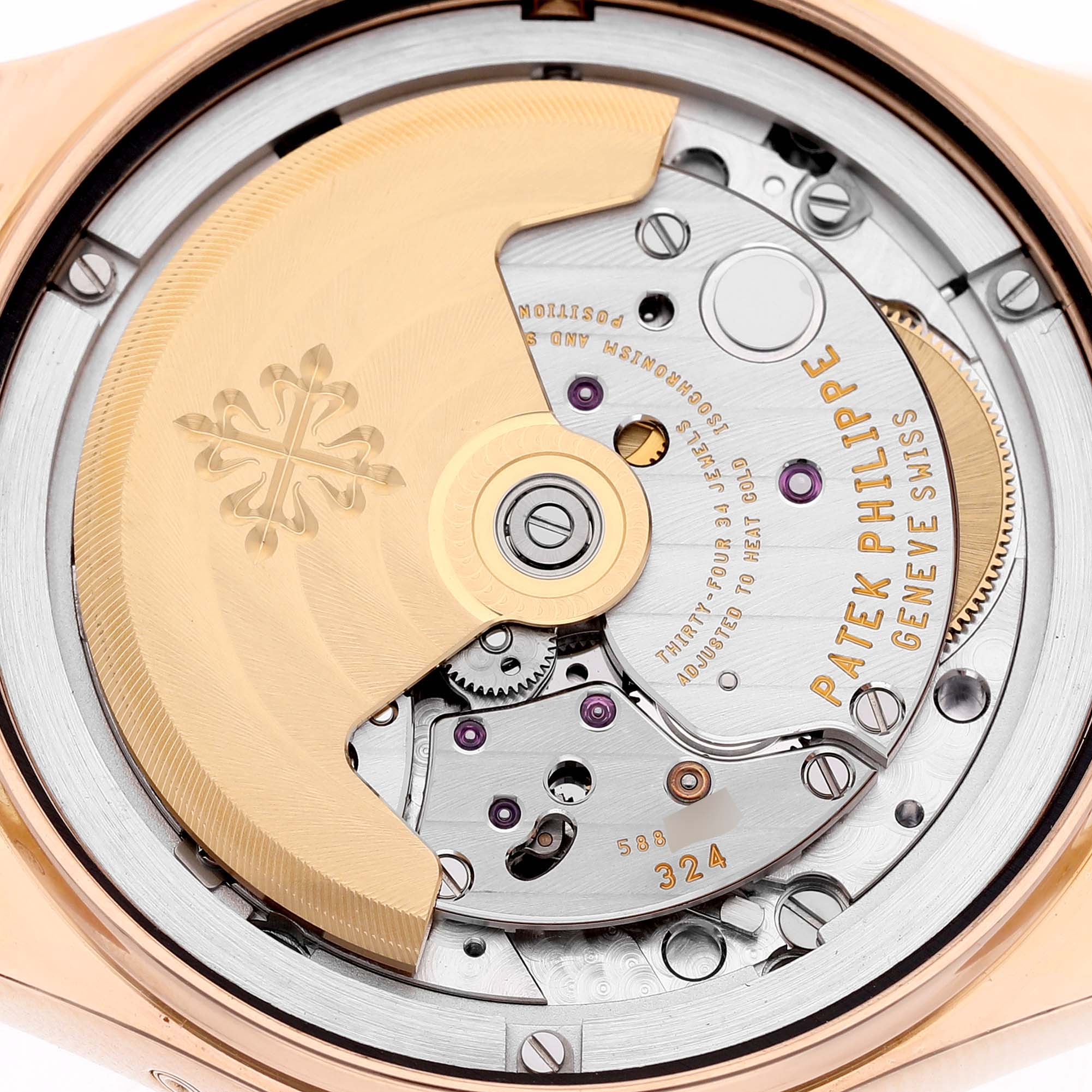 The image shows a detailed close-up of the movement of a Patek Philippe Complications 4936R-001 Men's Rose Gold Mother of Pearl Dial watch, highlighting the rotor and intricate mechanics.