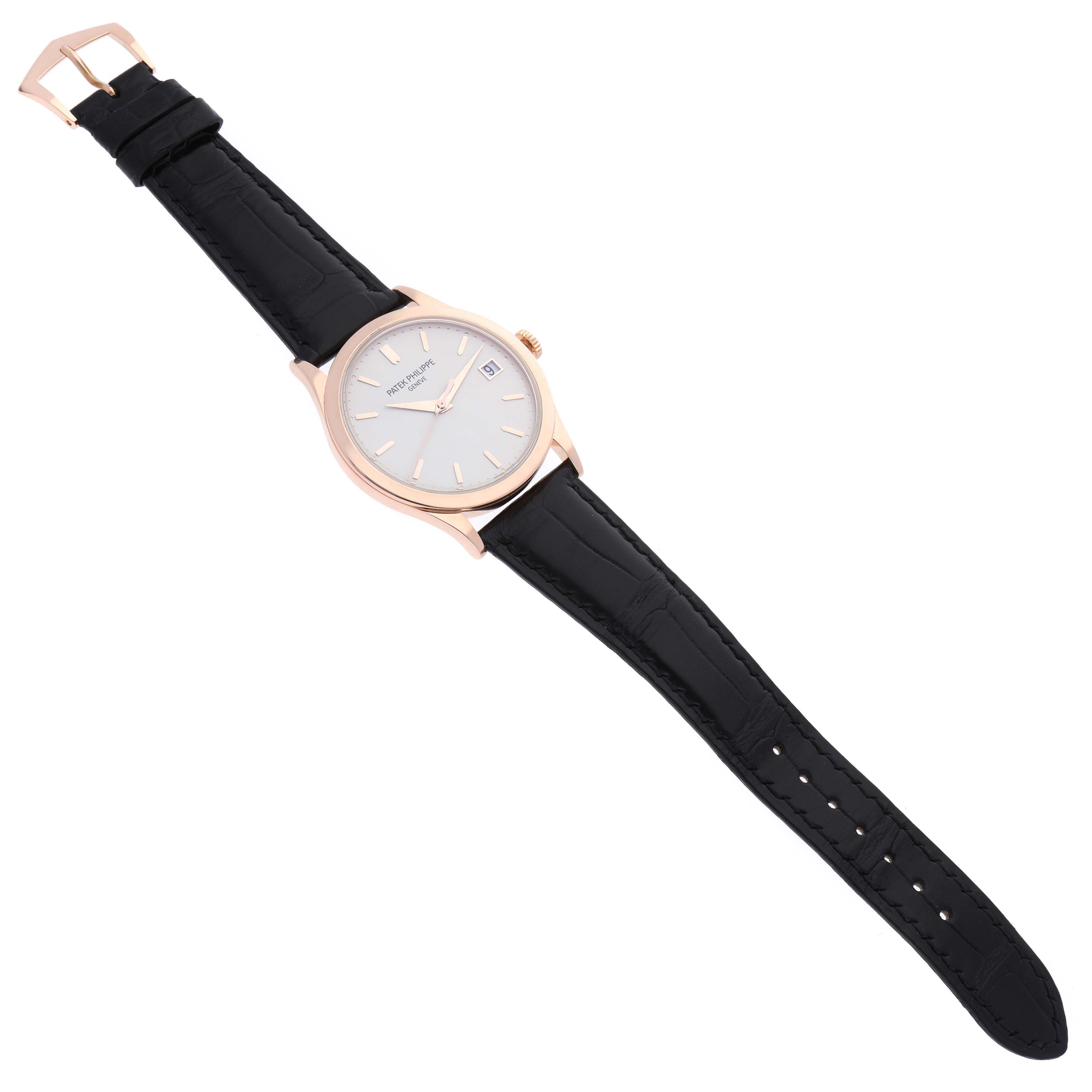The image shows a Patek Philippe Calatrava 5296R-010 Men's Rose Gold Silver Dial 5296R-010 Men's Rose Gold Silver Dial watch from an overhead view, highlighting its black leather strap and round dial.