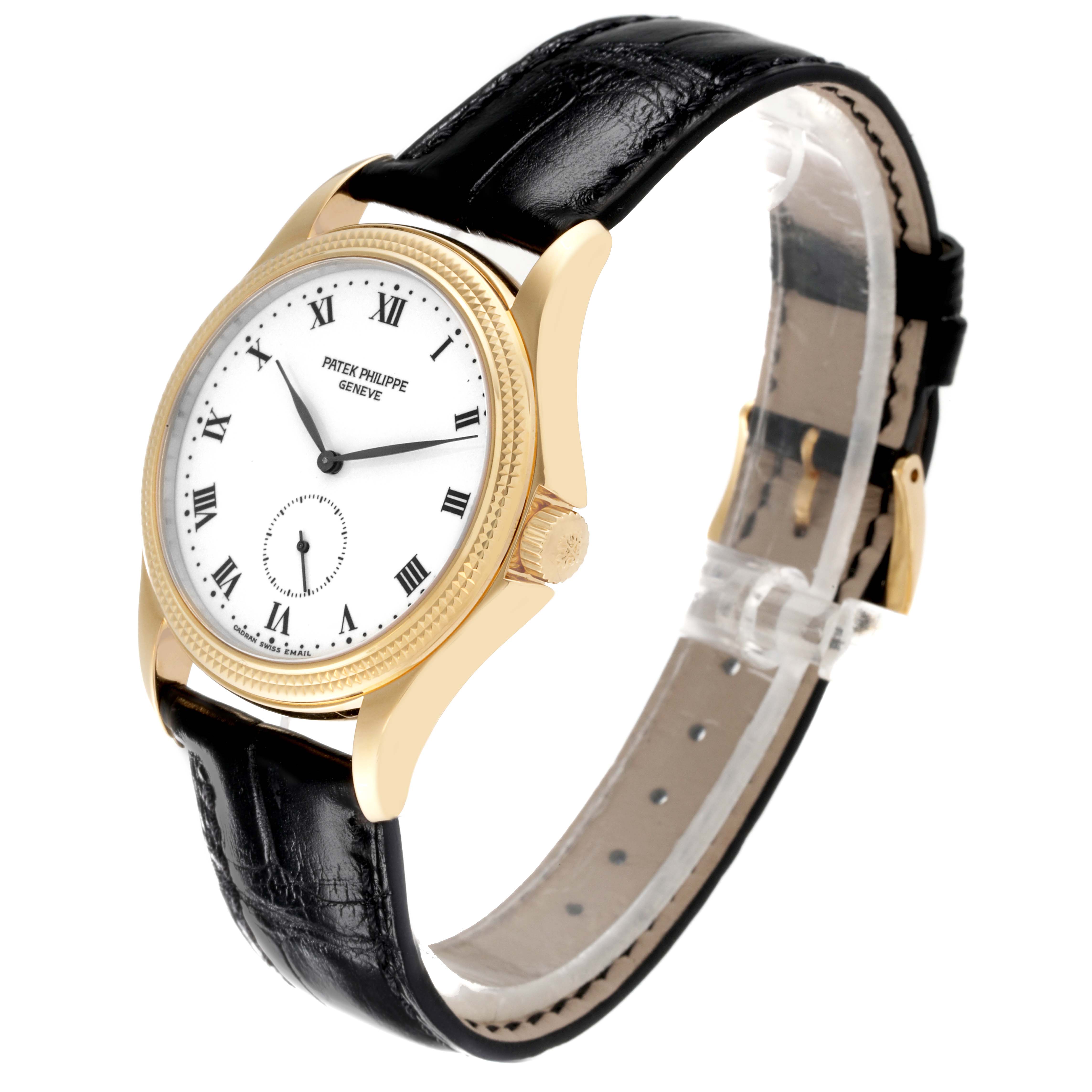 The image shows a Patek Philippe Calatrava 5115J Men's Yellow Gold White Dial 5115J Men's Yellow Gold White Dial watch, viewed at an angle showcasing the dial, case, crown, and strap.
