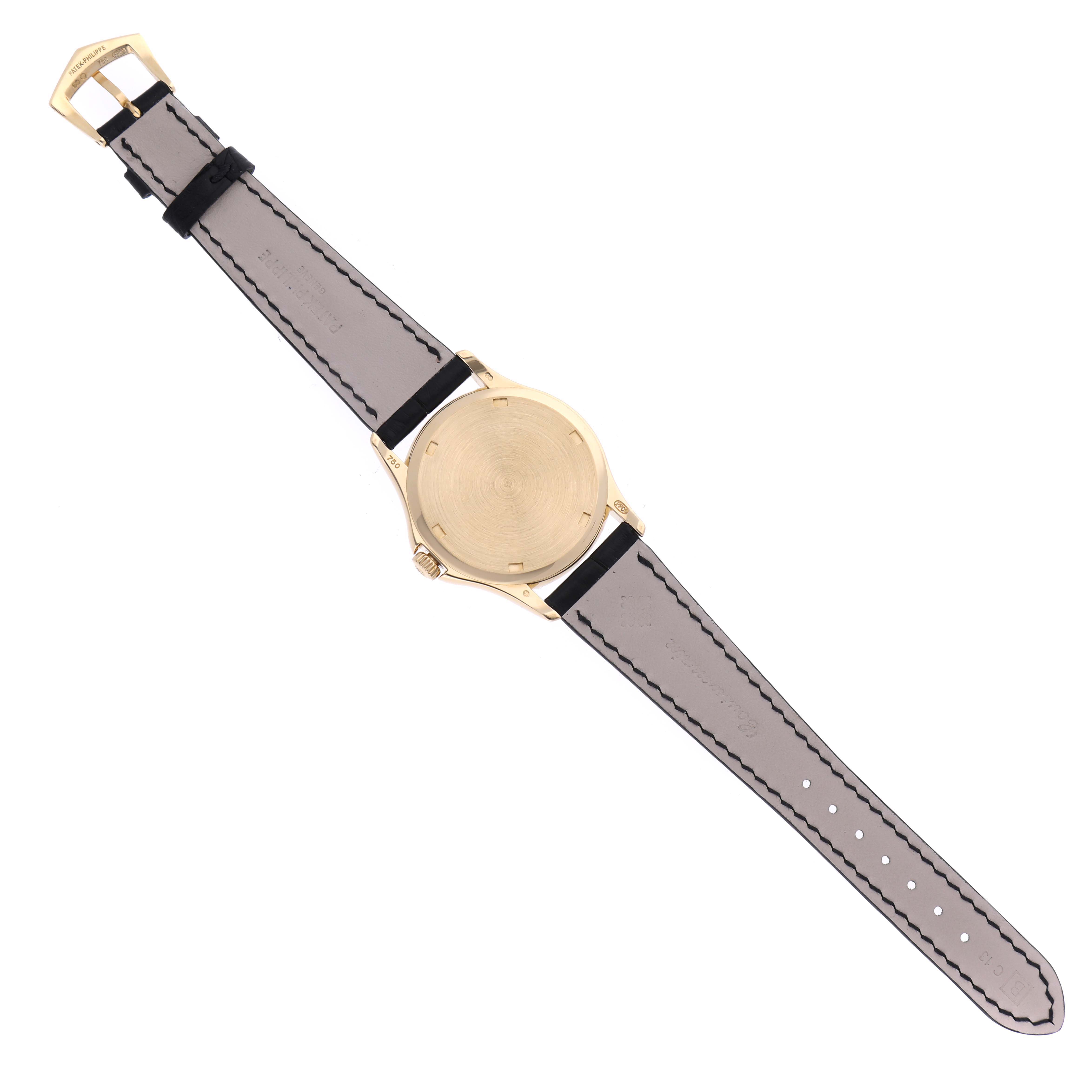 The image shows the back view of a Patek Philippe Calatrava 5115J Men's Yellow Gold White Dial 5115J Men's Yellow Gold White Dial model watch, displaying its strap and case back.