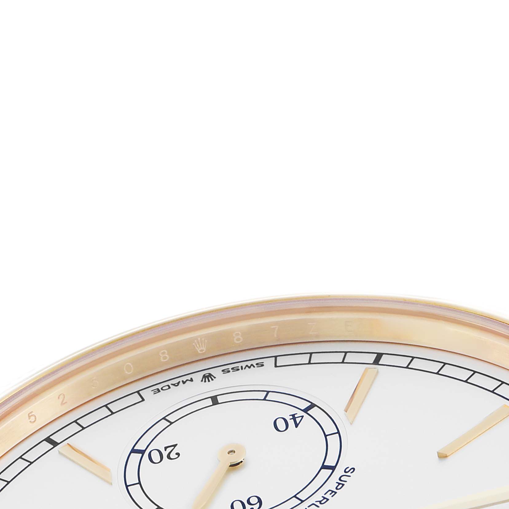 The image shows the edge and partial face of a Rolex 1908 52508-0006 Men
s Yellow Gold White Dial watch, featuring the bezel, minute markings, and part of the dial.