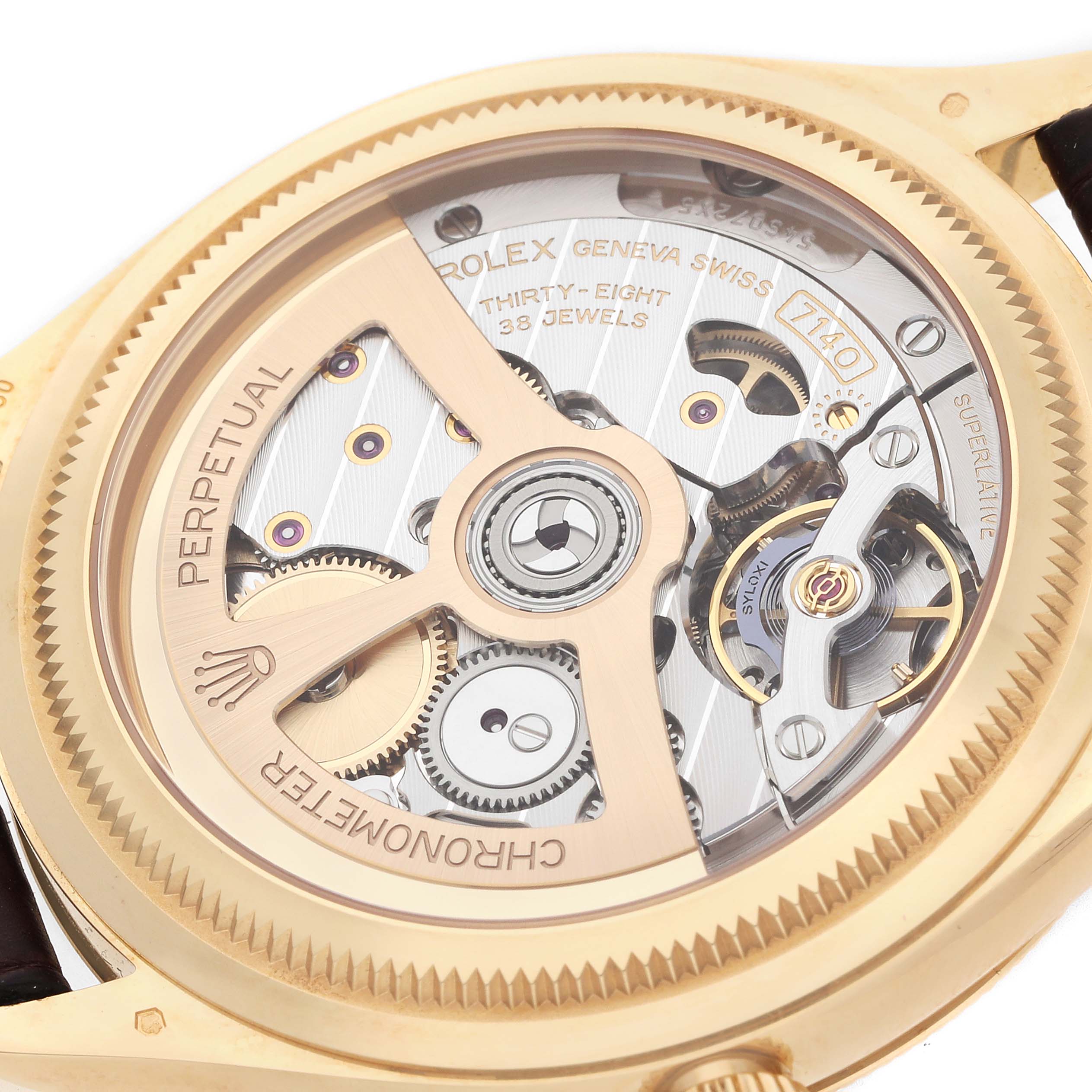 The image shows the open back view of a Rolex 1908 52508-0006 Men
s Yellow Gold White Dial model, highlighting its intricate movement gears and components.