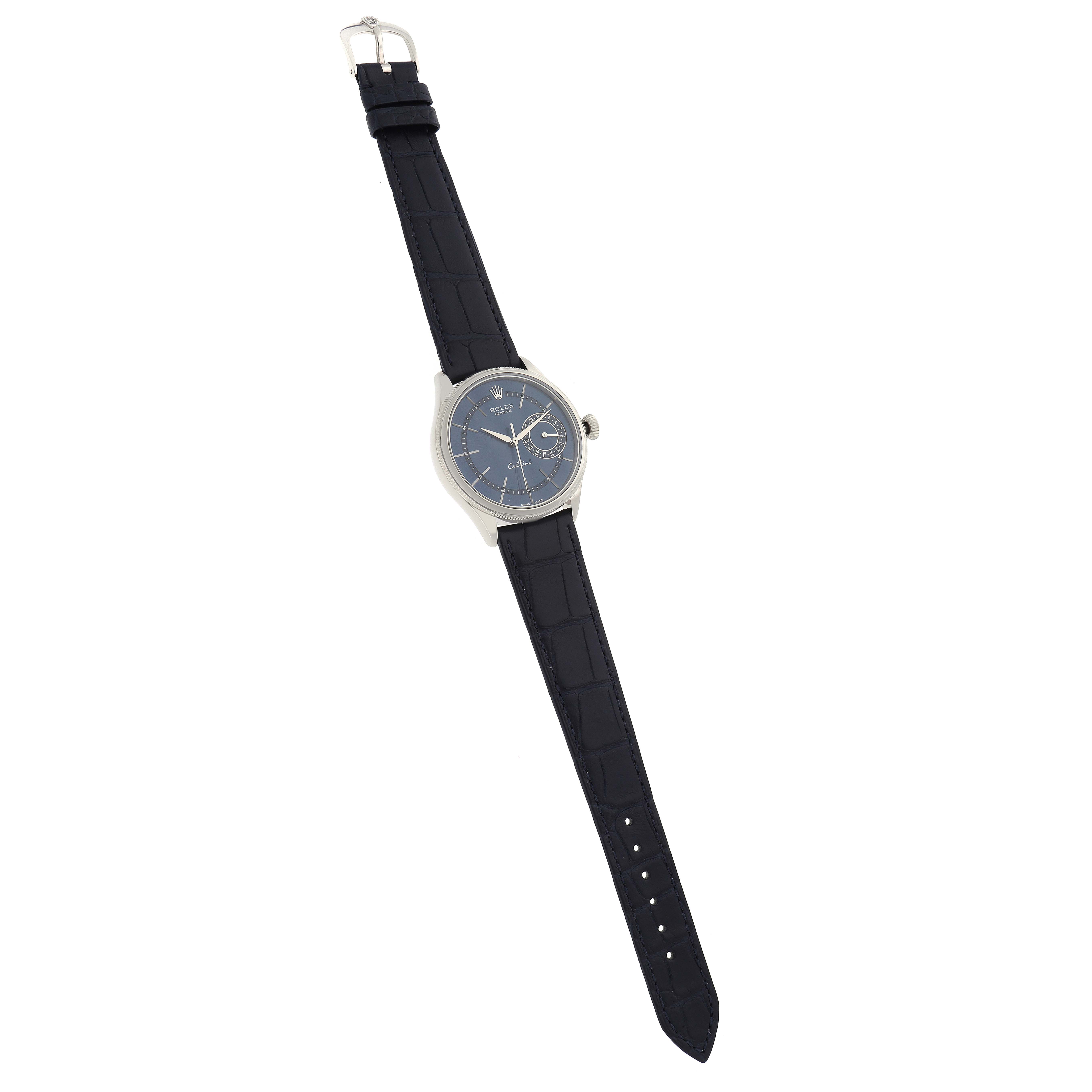 The Rolex Cellini 50519 Men
s White Gold Blue Dial model is shown in a top-down view, displaying the entire watch with a dark strap and silver case.