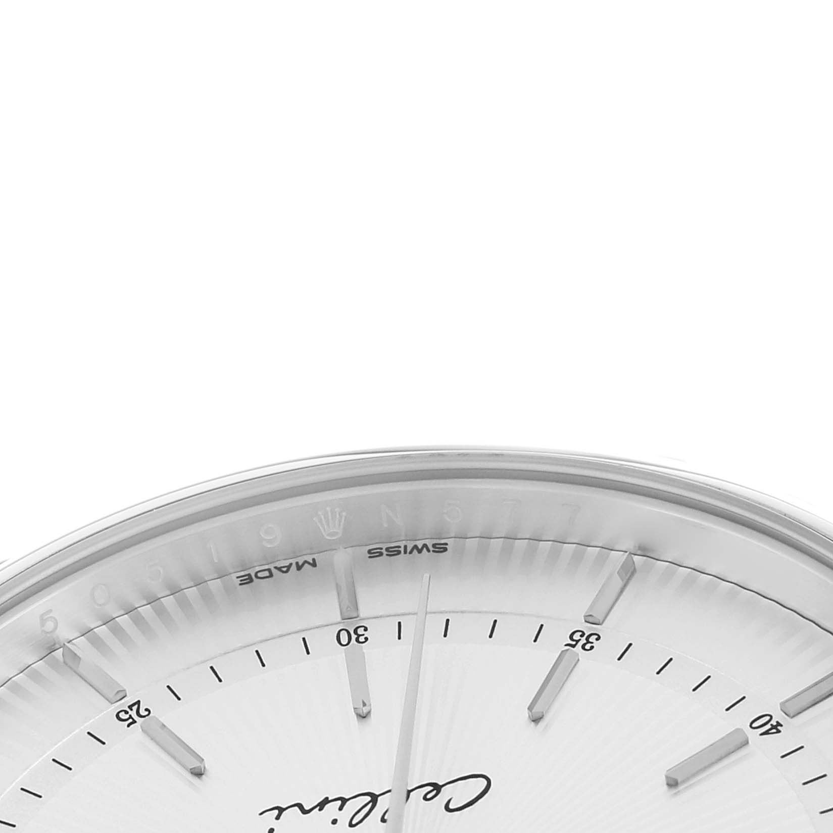 The image shows the upper section of a Rolex Cellini 50519 Men
s White Gold White Dial watch face, highlighting the minute markers and part of the branding.