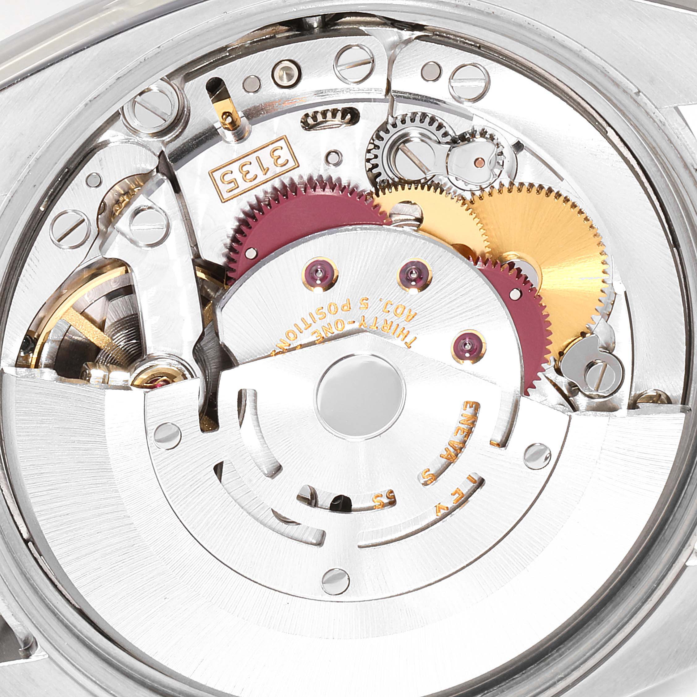 This close-up image shows the intricate movement mechanism of a Rolex Date 115200 Men's Stainless Steel White Dial 115200 Men's Stainless Steel White Dial model watch.