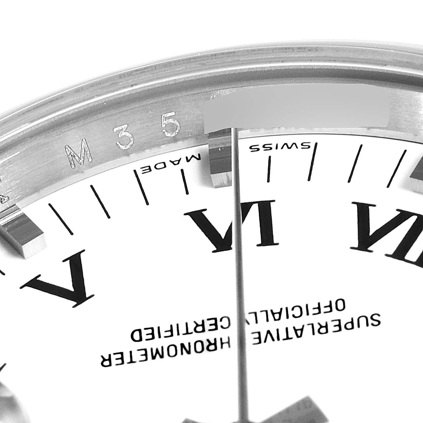 The close-up angle shows the dial and part of the bezel of the Rolex Date 115200 Men's Stainless Steel White Dial 115200 Men's Stainless Steel White Dial model, including Roman numerals and text details.