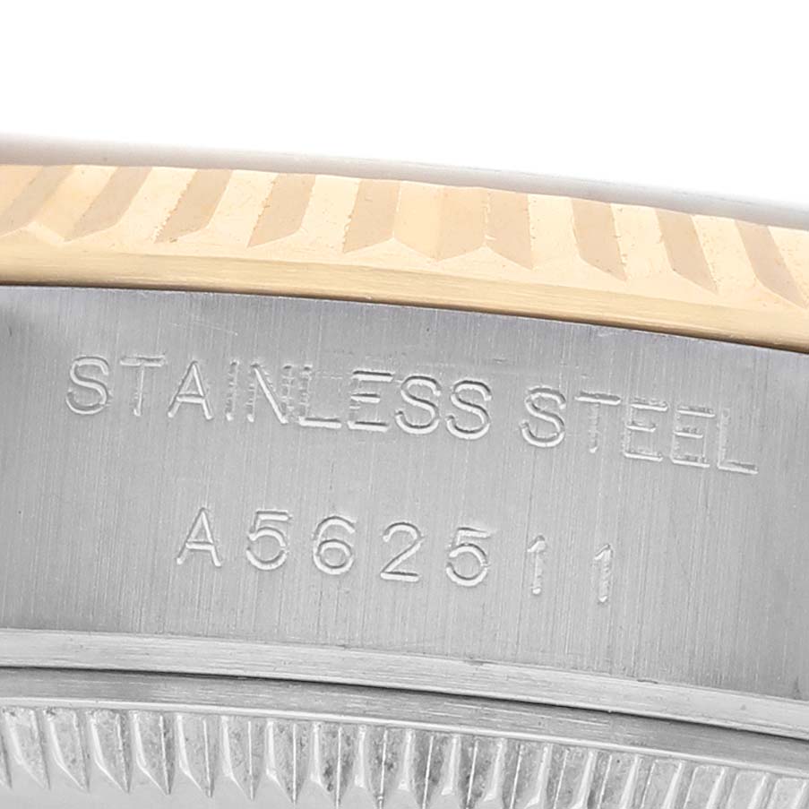 The image shows a close-up of the outer edge of a Rolex Datejust 79173 Women's Stainless Steel Champagne Dial watch, highlighting the steel casing with engraving.