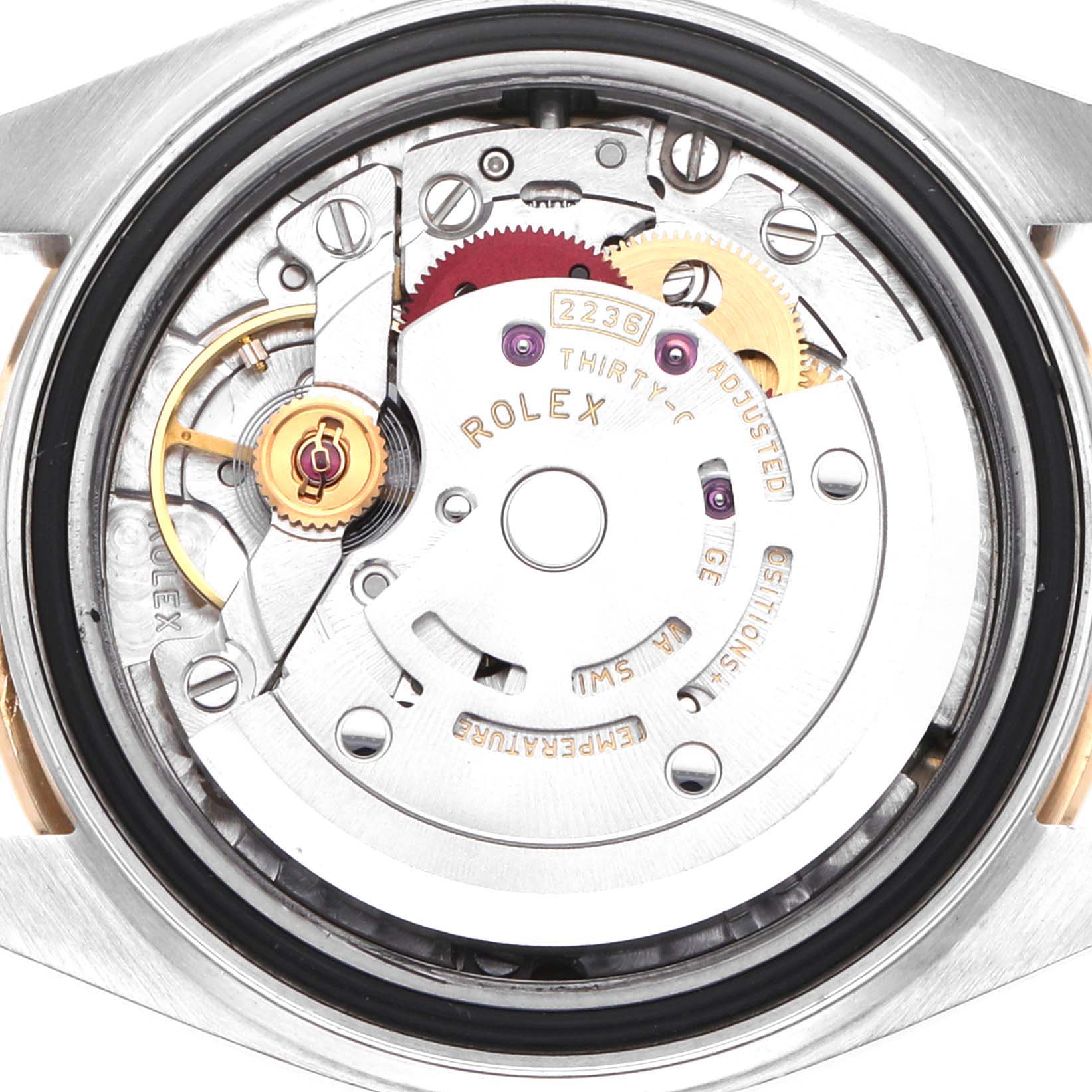 The image shows a top view of the Rolex Datejust 279383 Women
s Steel and Gold (two tone) Champagne Dial movement, highlighting the intricate gears and components.
