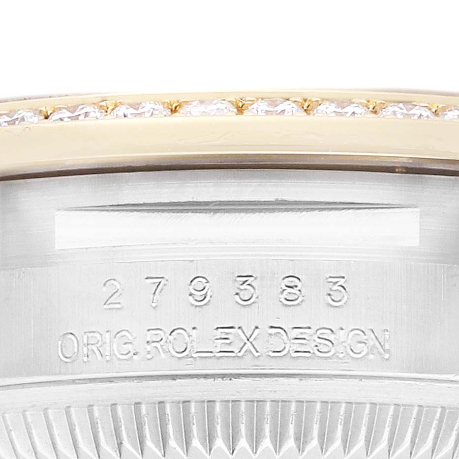 This image shows a close-up of the Rolex Datejust 279383 Women
s Steel and Gold (two tone) Champagne Dial case side, featuring engraved serial numbers and partial view of a gem-set bezel.