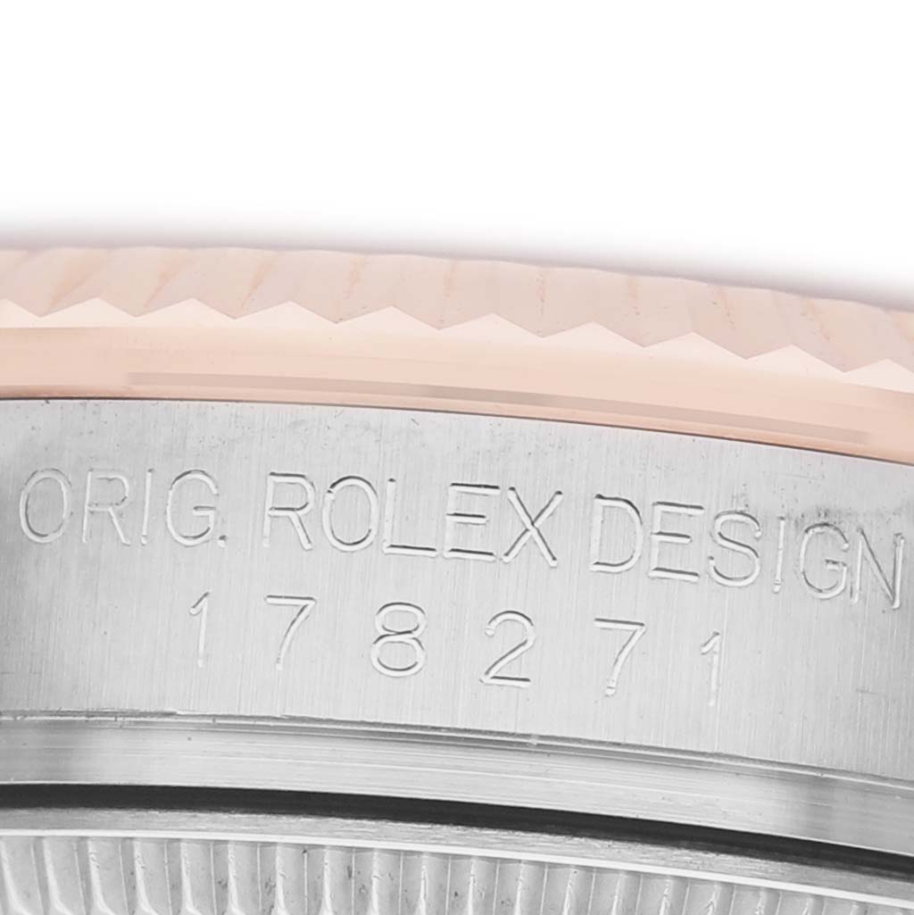 The image shows a close-up of the edge of a Rolex Datejust 178271 Women's Stainless Steel White Dial, focusing on the bezel and engraved part of the case.