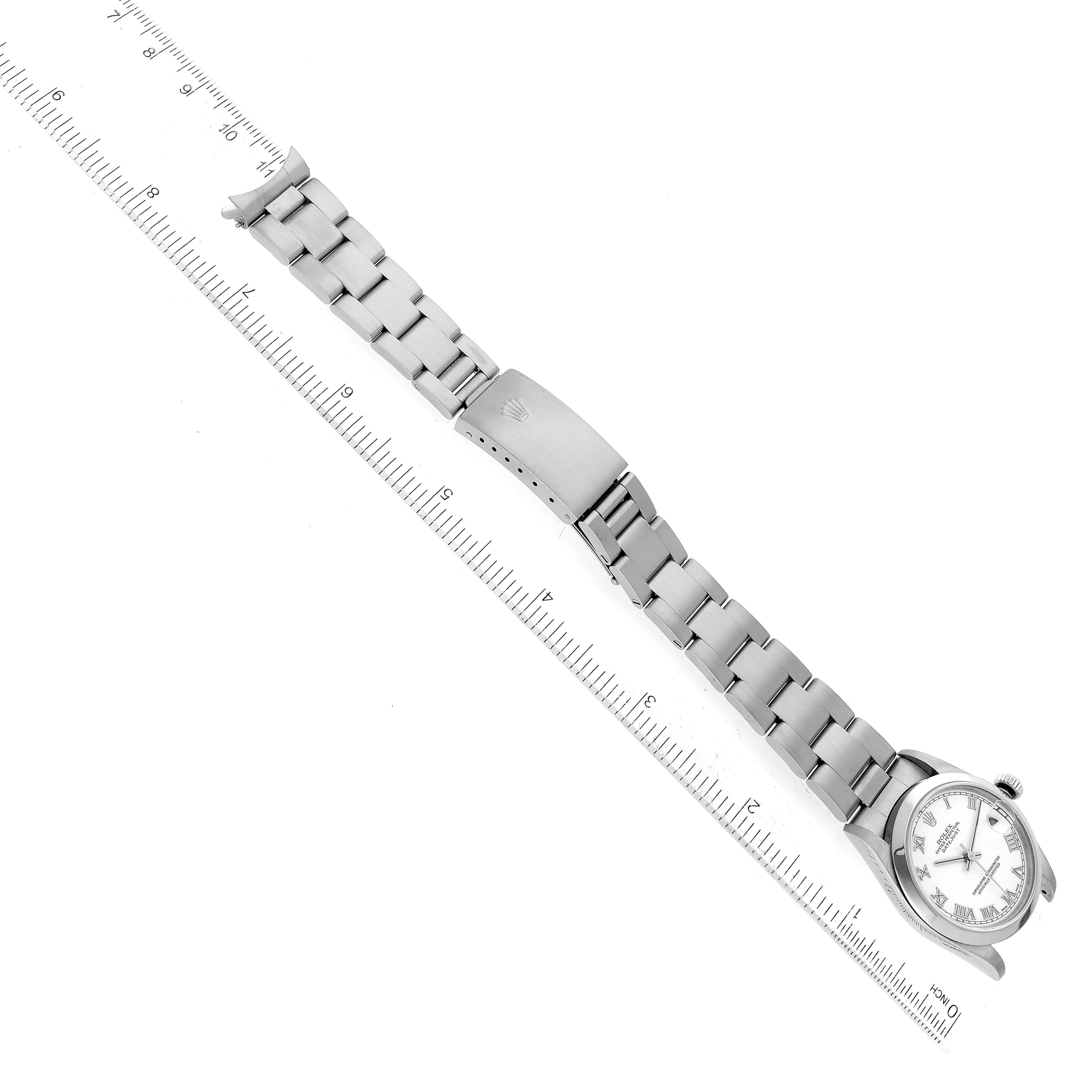 The image shows a fully extended Rolex Mid-Size 78240 Women's Stainless Steel White Dial 78240 Women's Stainless Steel White Dial watch, including the face, band, and clasp, next to a ruler for size reference.