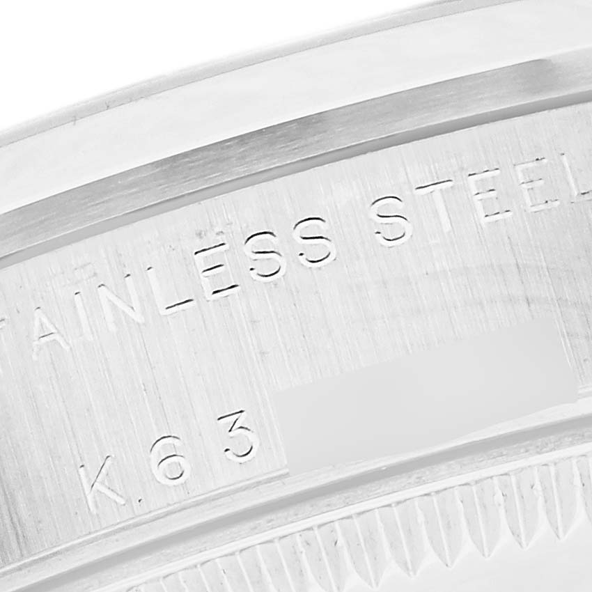This close-up image shows the stainless steel case back of a Mid-Size Rolex watch.