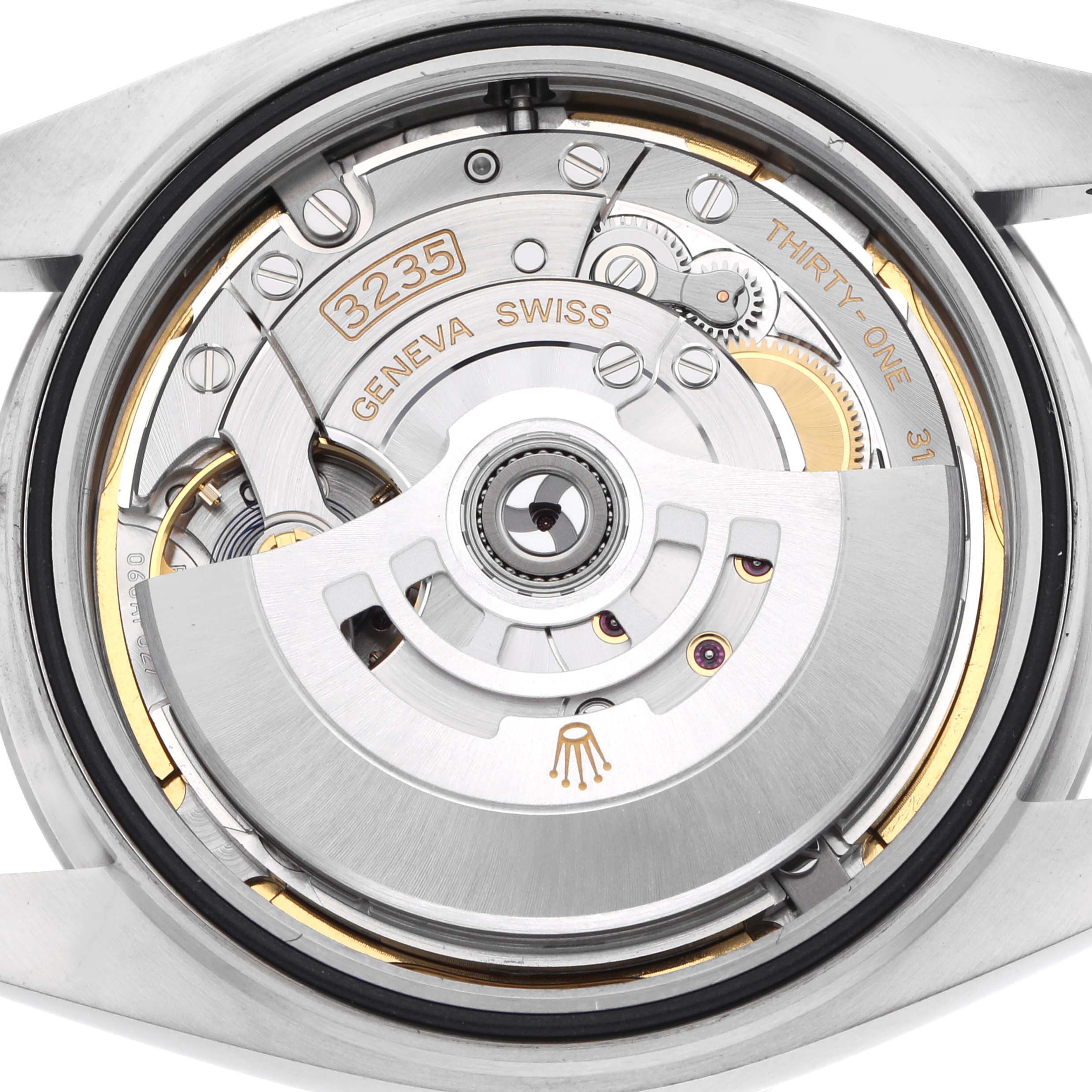 This image shows the movement of a Rolex Datejust 126300 Men
s Stainless Steel Blue Dial watch from a back angle, highlighting the rotor and caliber details.