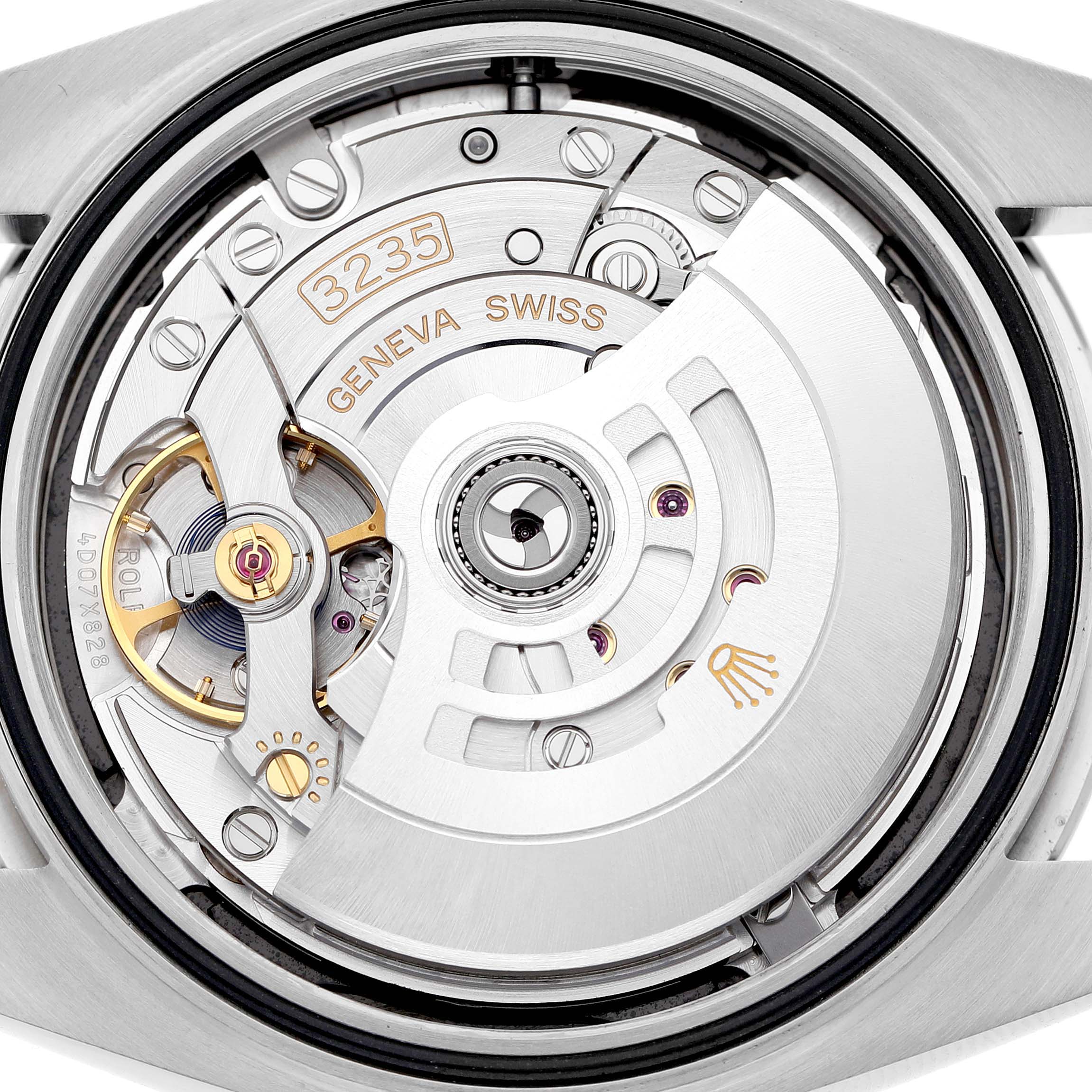 The image shows the movement of the Rolex Datejust 41 126300 Men's Stainless Steel Black Dial, showcasing the rotor and intricate internal components.