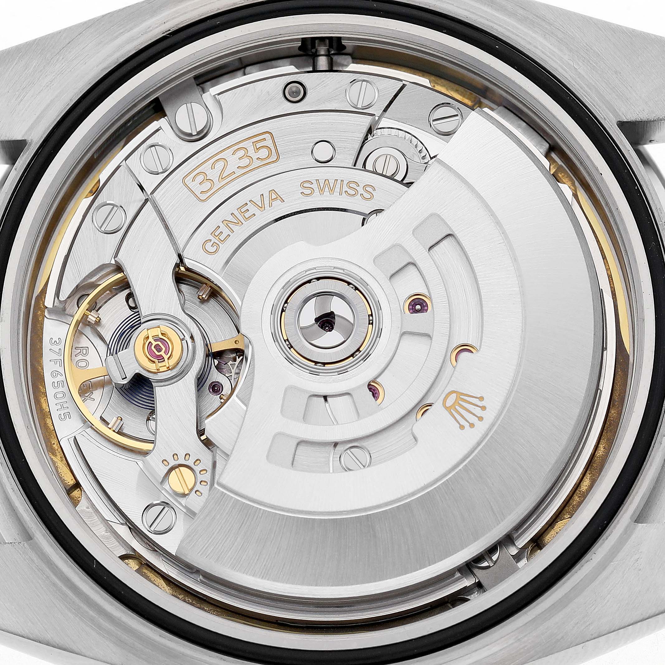 The image shows the movement interior of a Rolex Datejust 41 126300 Men's Stainless Steel White Dial, highlighting the rotor and intricate details.