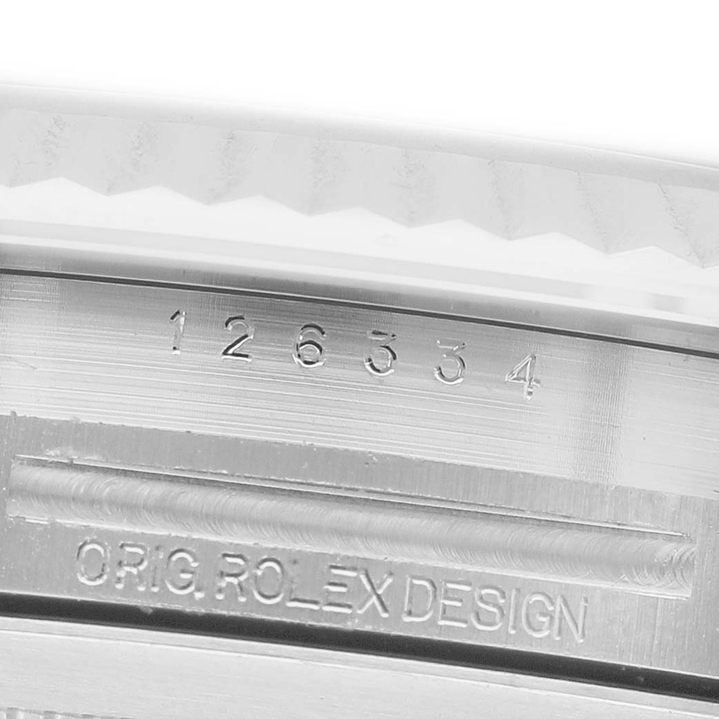 The image shows a close-up of the Rolex Datejust 41 126334 Men's Steel and Gold (two tone) Blue Dial watch, focusing on the engraved model number and “ORIG ROLEX DESIGN” on the case side.