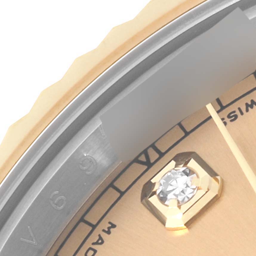 This close-up image of the Rolex Datejust 41 116333 Men's Steel and Gold (two tone) Champagne Dial 116333 Men's Steel and Gold (two tone) Champagne Dial watch shows the bezel, part of the dial, and a diamond-set hour marker.