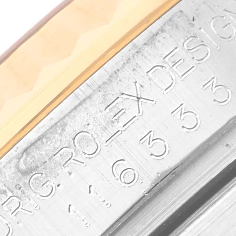 The image shows a close-up of the engraved inner case and the edge of the bezel of a Rolex Datejust 41 116333 Men's Steel and Gold (two tone) Champagne Dial 116333 Men's Steel and Gold (two tone) Champagne Dial watch.