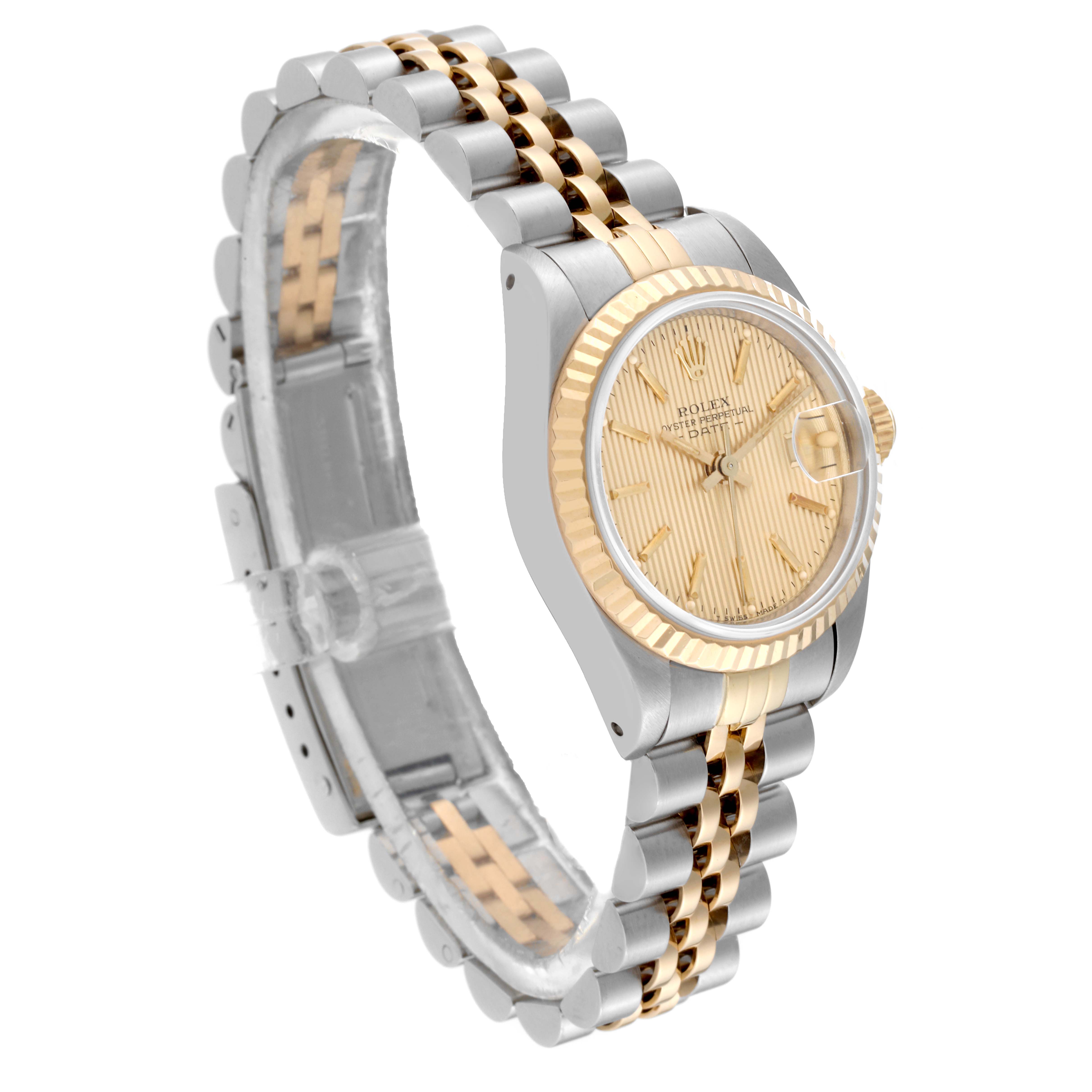 This Rolex Datejust 69173 Women's Steel and Gold (two tone) Champagne Dial 69173 Women's Steel and Gold (two tone) Champagne Dial watch is shown at an angled side view, displaying its champagne dial, fluted bezel, and two-toned jubilee bracelet.