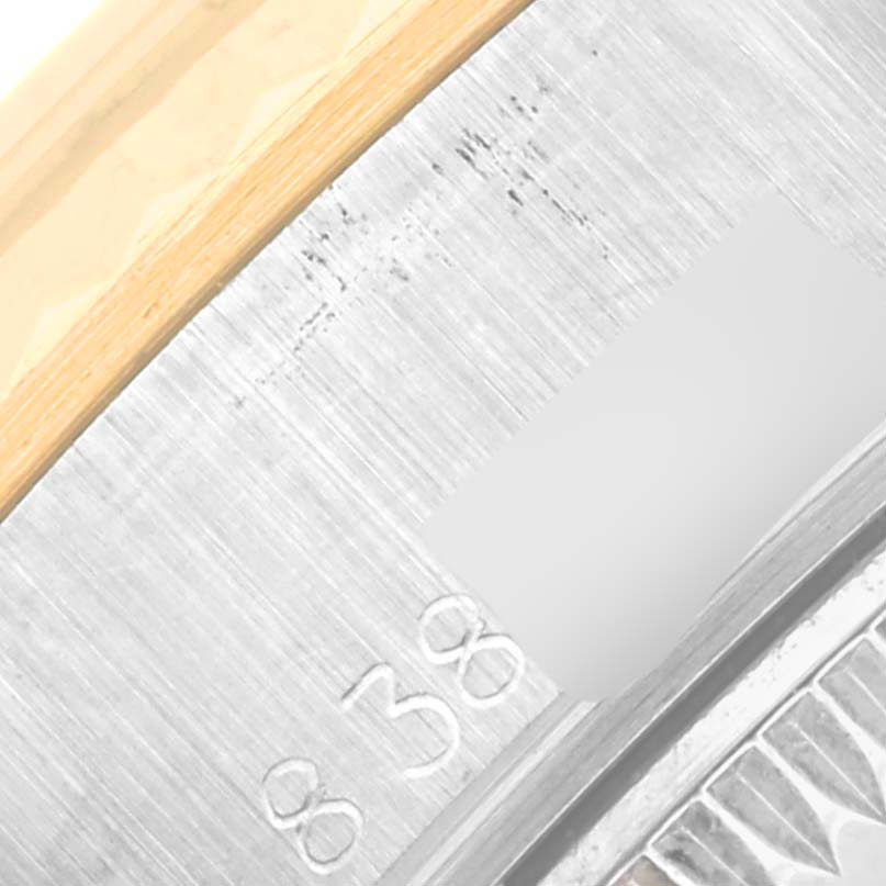 The image shows a close-up of the engraved serial number area on the side of the bezel of a Rolex Datejust 69173 Women's Steel and Gold (two tone) Champagne Dial 69173 Women's Steel and Gold (two tone) Champagne Dial watch.