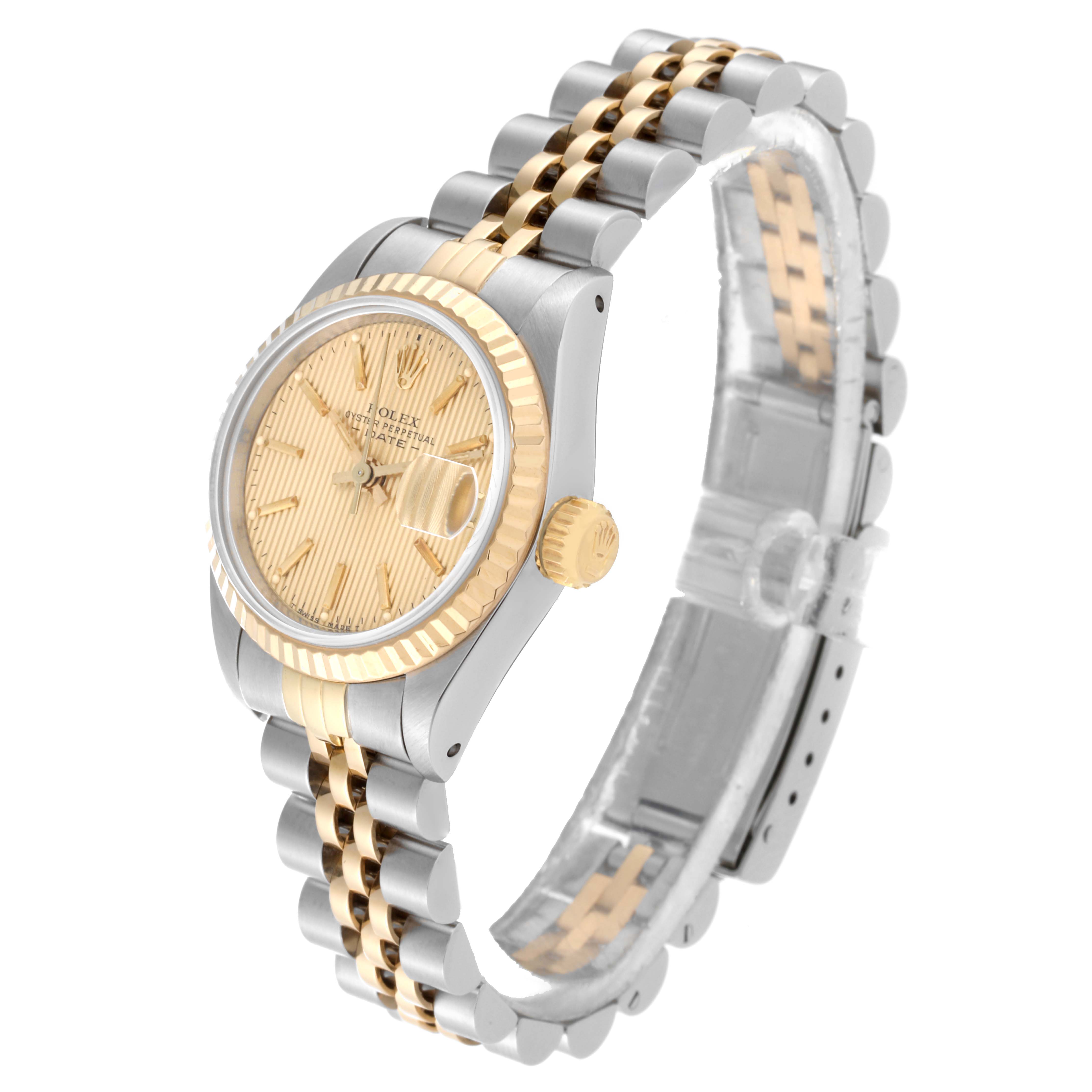This image shows a side angle of the Rolex Datejust 69173 Women's Steel and Gold (two tone) Champagne Dial 69173 Women's Steel and Gold (two tone) Champagne Dial watch, highlighting the gold bezel, crown, face, and the two-tone bracelet.