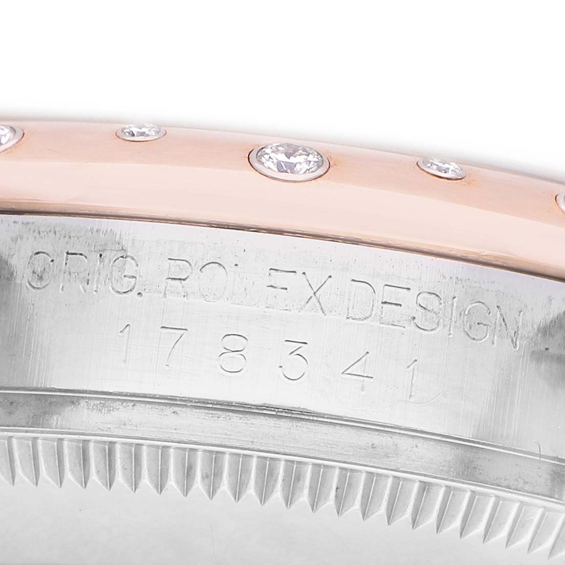 The image shows a close-up of the side of a Rolex Datejust 178341 Women's Steel and Gold (two tone) White Dial, featuring the serial number and diamond-studded bezel.