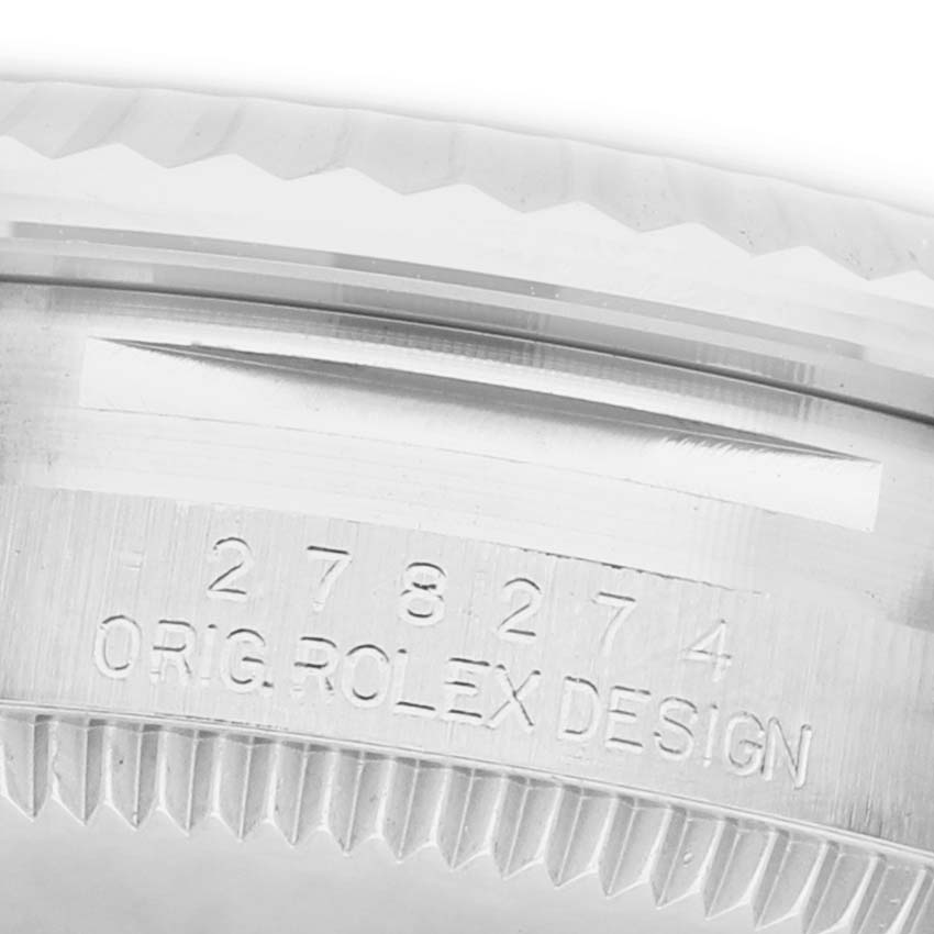 The image shows a close-up of the case side and rehaut of the Rolex Datejust 278274 Women's Stainless Steel Purple Dial, highlighting the engraved serial number and "ORIG ROLEX DESIGN."