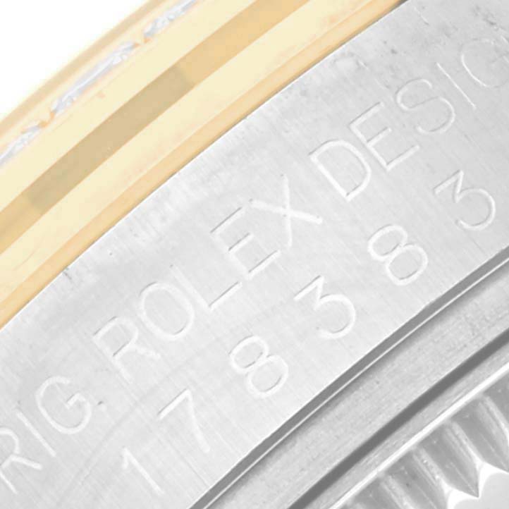 This image shows an angle of the side case and bezel of a Rolex Mid-Size 178383 Women's Steel and Gold (two tone) Mother of Pearl Dial 178383 Women's Steel and Gold (two tone) Mother of Pearl Dial model with visible engraved text.