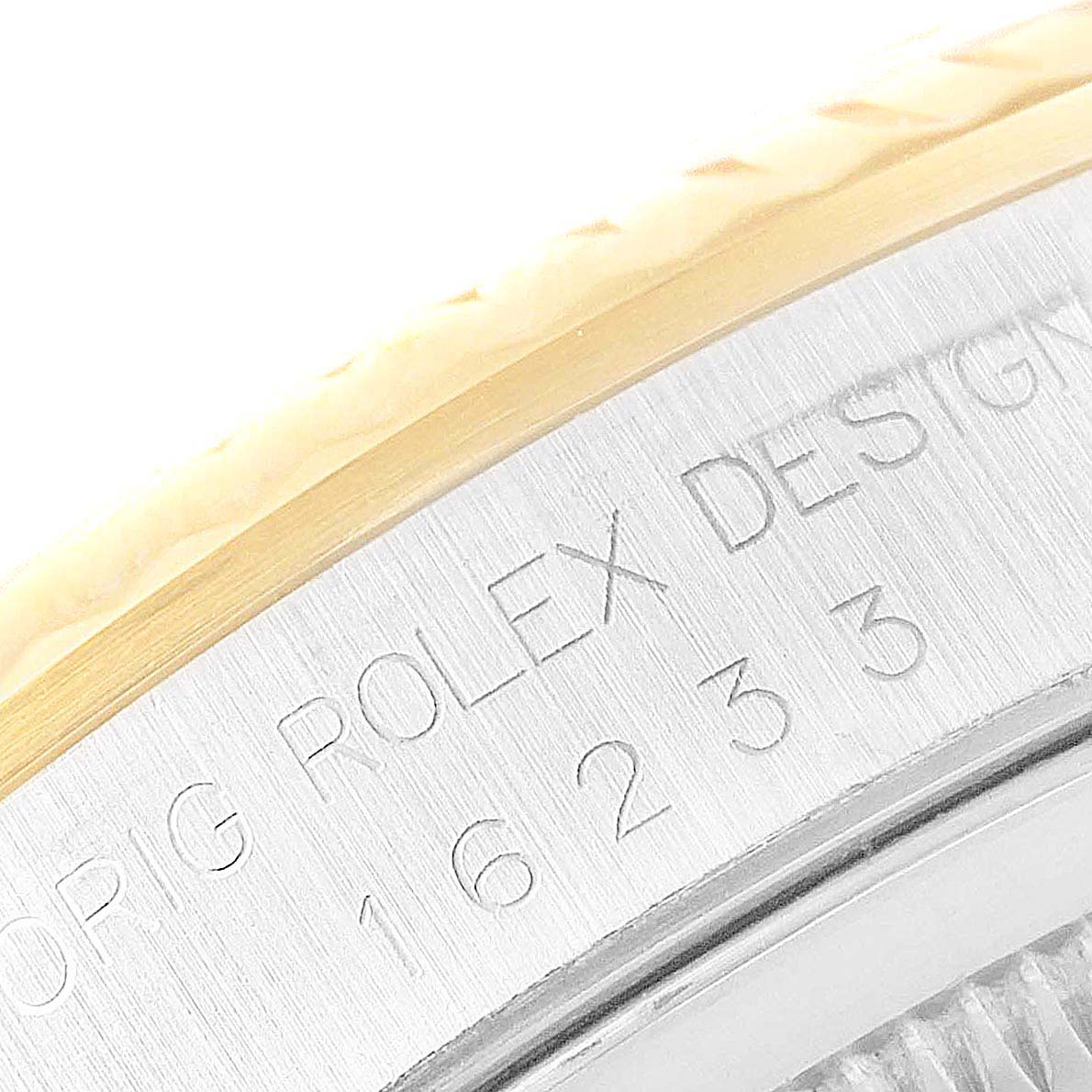 The image shows a close-up of the engraved bezel edge and model number of the Rolex Datejust 16233 Men
s Steel and Gold (two tone) Champagne Dial 16233 Men
s Steel and Gold (two tone) Champagne Dial watch.