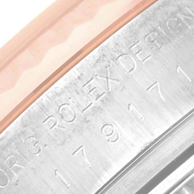 The image shows a close-up of the engraved edge, revealing the "ROLEX DESIGN" text on the bezel of a Rolex Datejust 179171 Women's Steel and Gold (two tone) Mother of Pearl Dial 179171 Women's Steel and Gold (two tone) Mother of Pearl Dial watch.