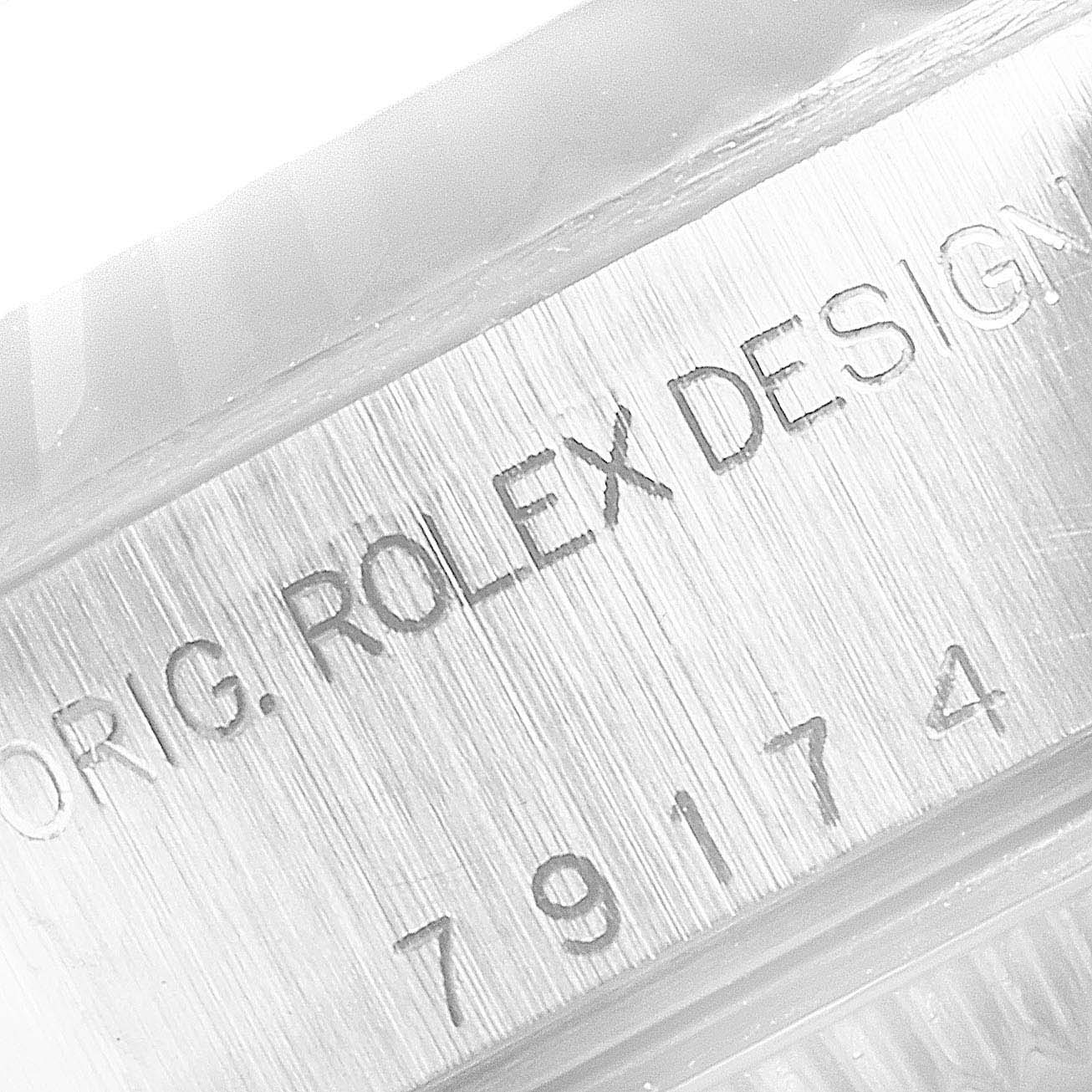 This image shows the engraved model number and design details on the case of a Rolex Datejust 79174 Women
s Stainless Steel Mother of Pearl Dial 79174 Women
s Stainless Steel Mother of Pearl Dial watch.