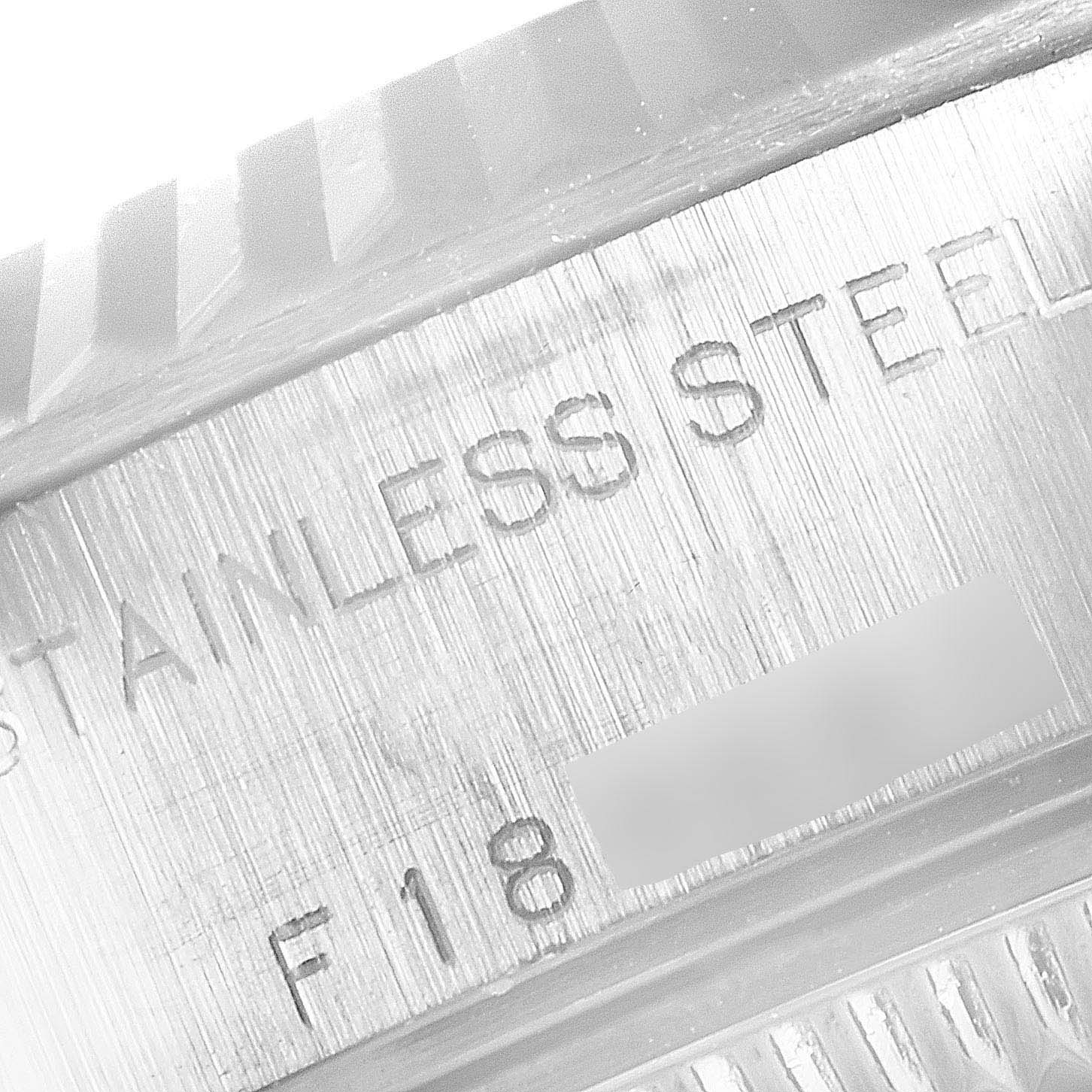 This image shows a close-up of the case back and bezel of a Rolex Datejust 79174 Women
s Stainless Steel Mother of Pearl Dial 79174 Women
s Stainless Steel Mother of Pearl Dial watch, focusing on the engraved text.