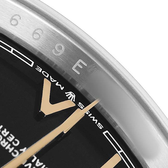The image shows a close-up of the dial and bezel edge of a Rolex Datejust 126233 Men's Steel and Gold (two tone) Black Dial, highlighting hour markers and the Rolex logo.