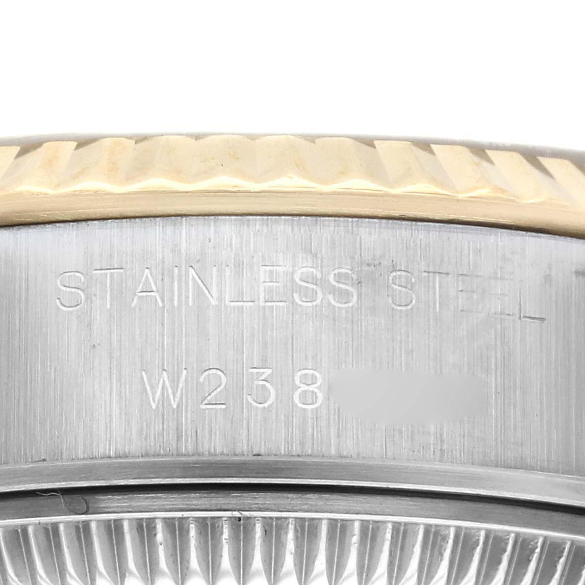 The image shows a close-up of the Rolex Datejust 69173 Women's Steel and Gold (two tone) Champagne Dial 69173 Women's Steel and Gold (two tone) Champagne Dial model's stainless steel case and part of the fluted bezel.