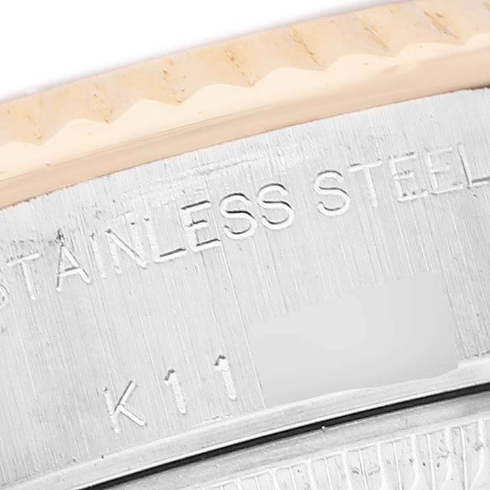The image shows a close-up of the case side of a Rolex Datejust 79173 Women's Steel and Gold (two tone) Champagne Dial, highlighting the stainless steel engraving.