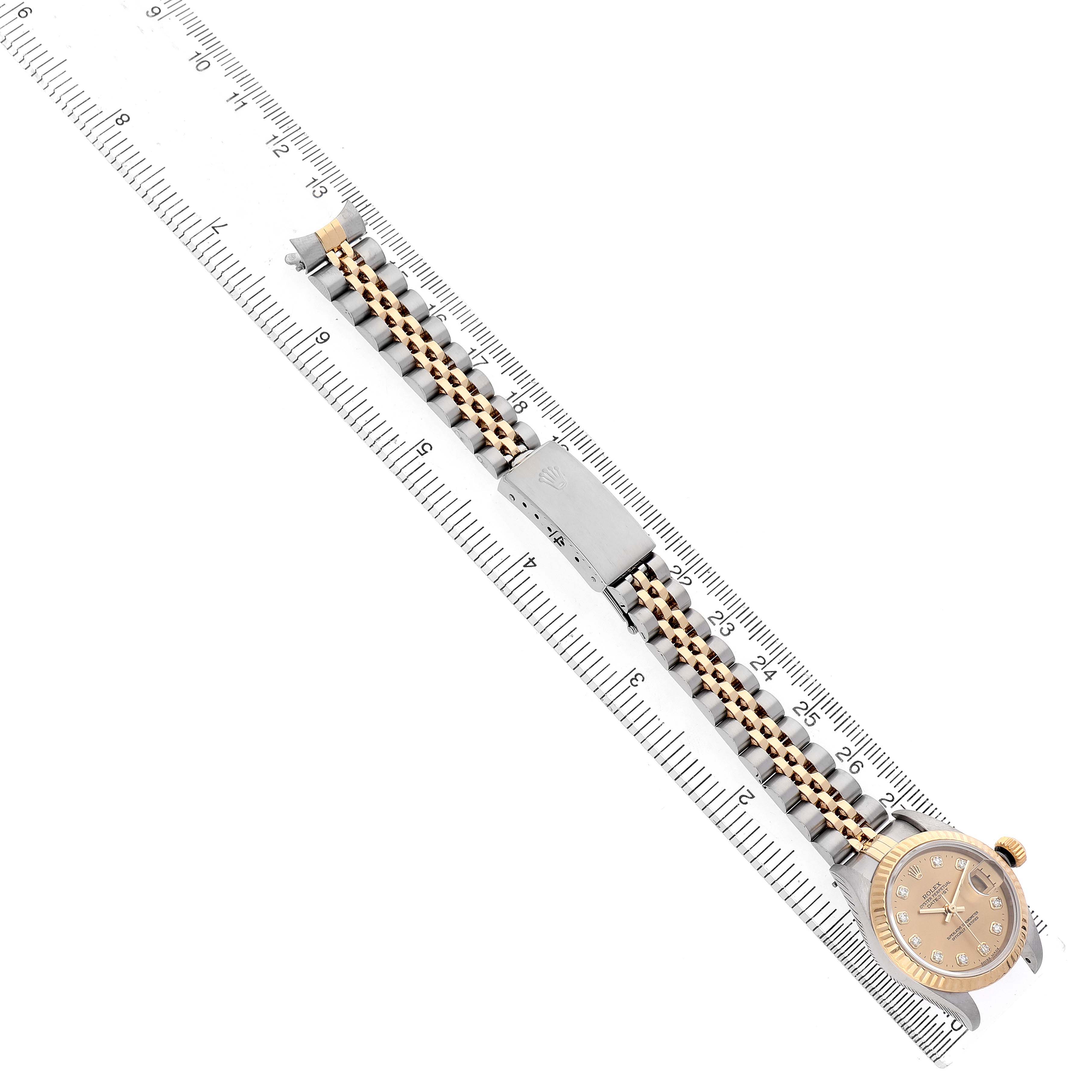 The Rolex Datejust 79173 Women's Steel and Gold (two tone) Champagne Dial watch is shown from a top-down angle, highlighting the full bracelet, clasp, and dial.