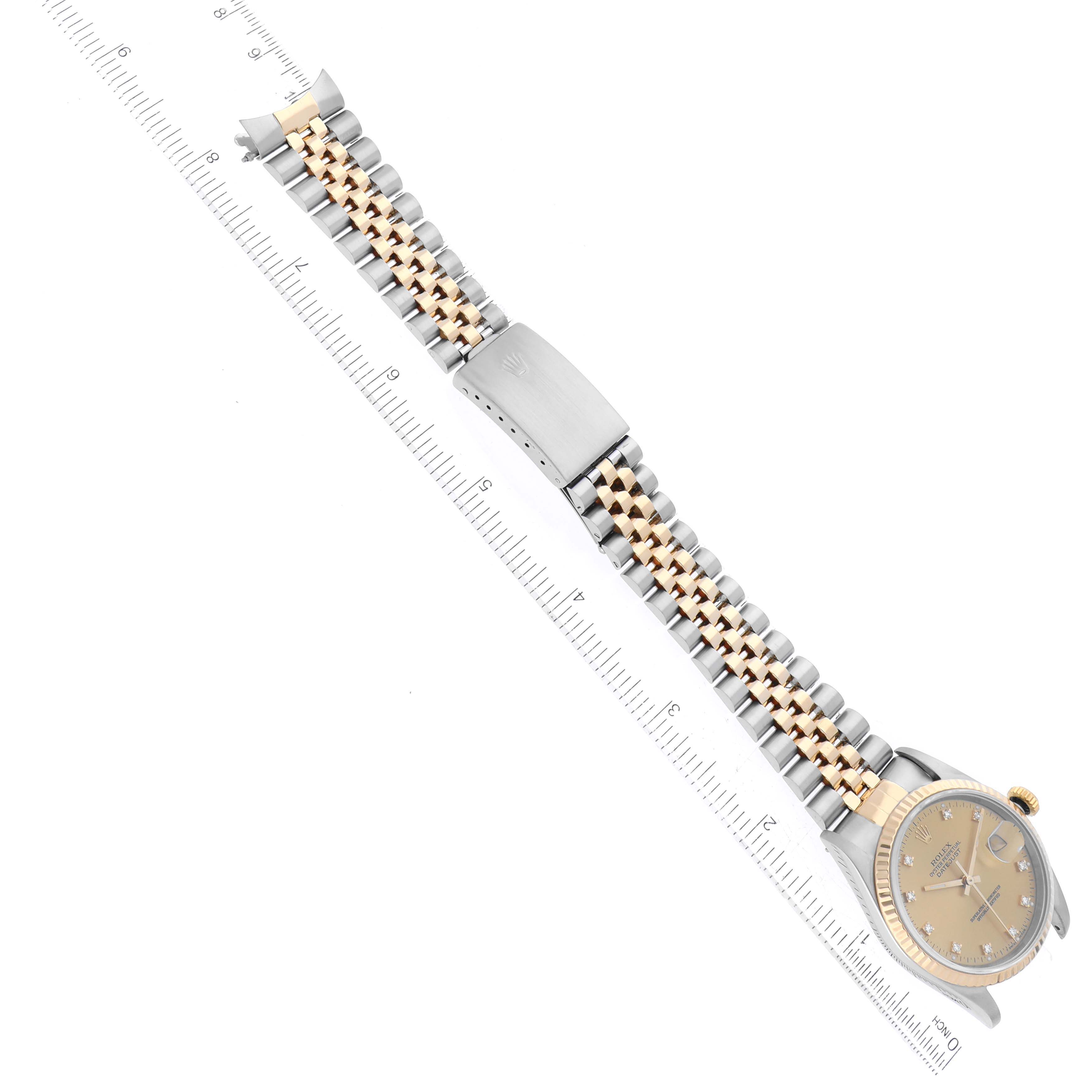 The Rolex Datejust 16233 Men's Steel and Gold (two tone) Champagne Dial 16233 Men's Steel and Gold (two tone) Champagne Dial watch is shown from a top-down angle, displaying the entire bracelet, clasp, and dial.