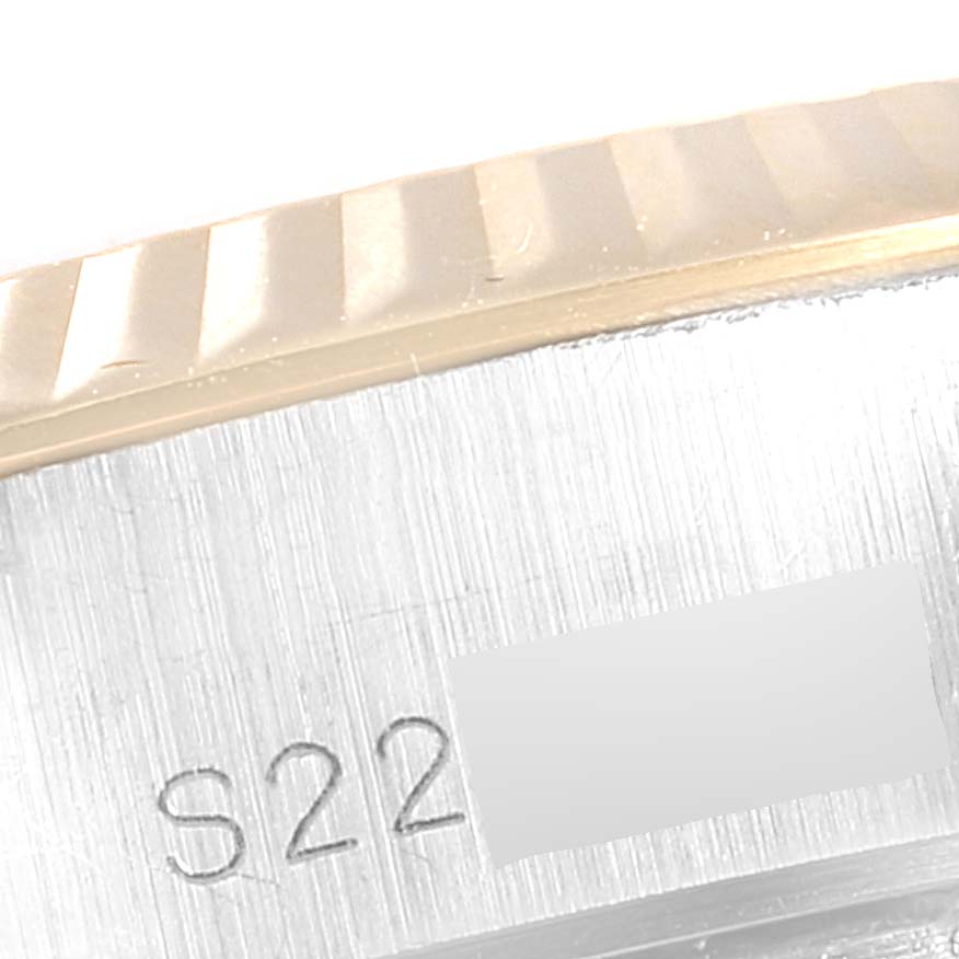 This image shows a close-up of the serial number area and fluted bezel of a Rolex Datejust 69173 Women
s Steel and Gold (two tone) Champagne Dial 69173 Women
s Steel and Gold (two tone) Champagne Dial watch.