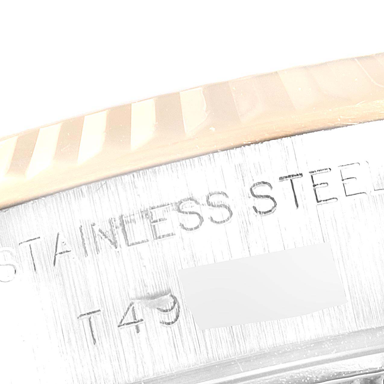 This image shows a close-up of the side marking on a stainless steel Rolex Datejust 69173 Women
s Steel and Gold (two tone) Champagne Dial 69173 Women
s Steel and Gold (two tone) Champagne Dial watch, including part of the bezel.