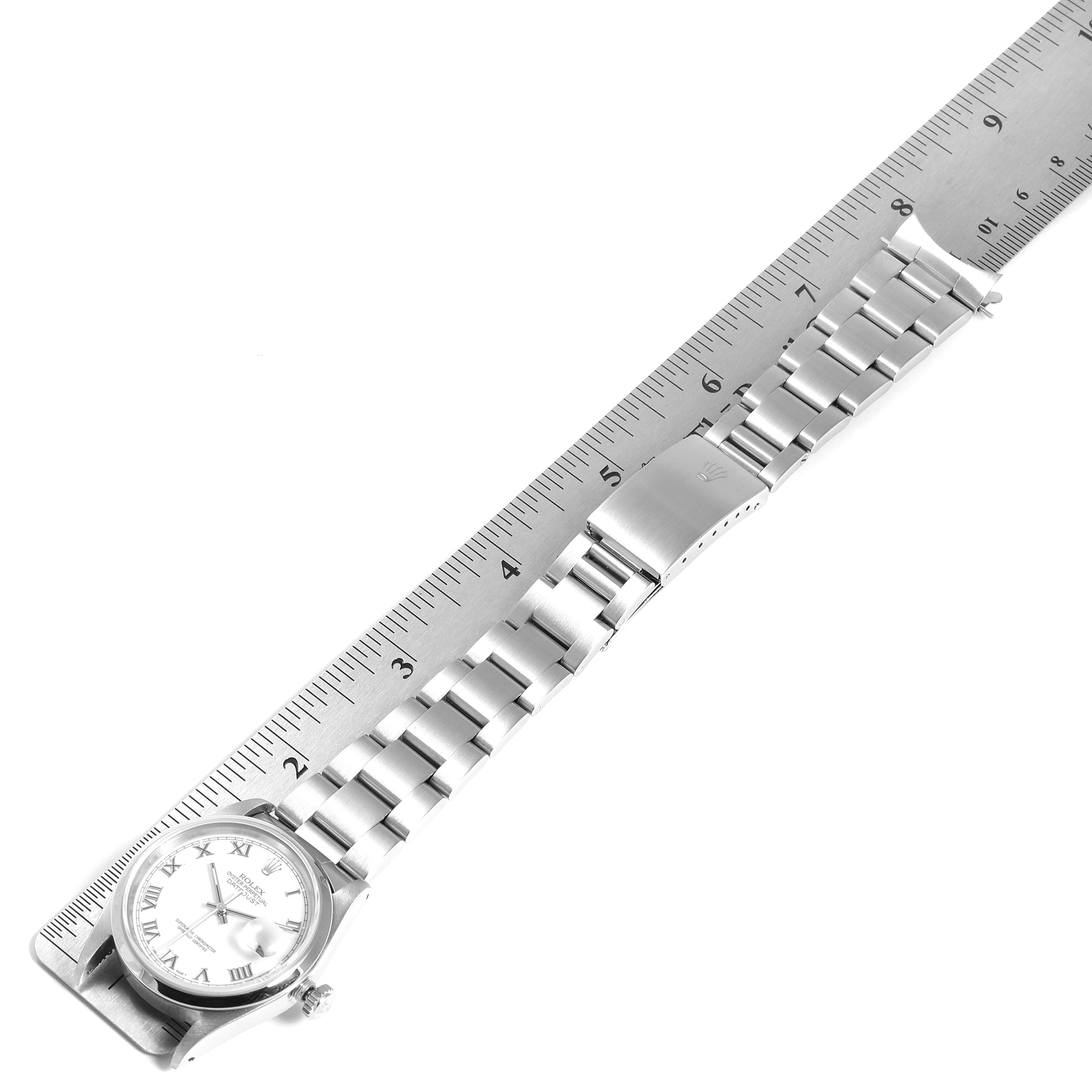 The image shows a top view of a Rolex Datejust 16200 Men's Stainless Steel White Dial 16200 Men's Stainless Steel White Dial watch with its bracelet laid flat next to a ruler.