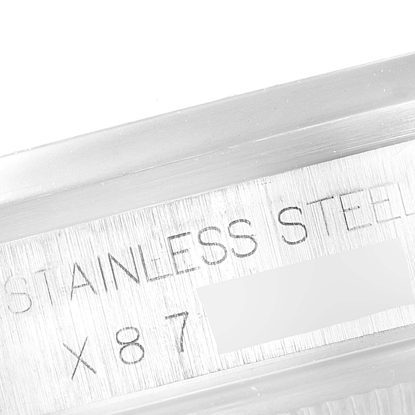 The image shows an angled close-up of the Datejust Rolex’s stainless steel engraved part.