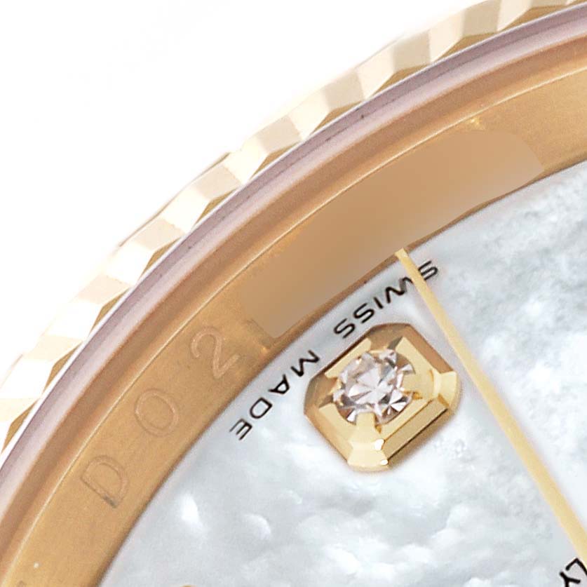 This close-up image of a Rolex Datejust 116238 Men's Yellow Gold Mother of Pearl Dial 116238 Men's Yellow Gold Mother of Pearl Dial watch shows a partial view of the bezel, dial, and a diamond marker at an angle.