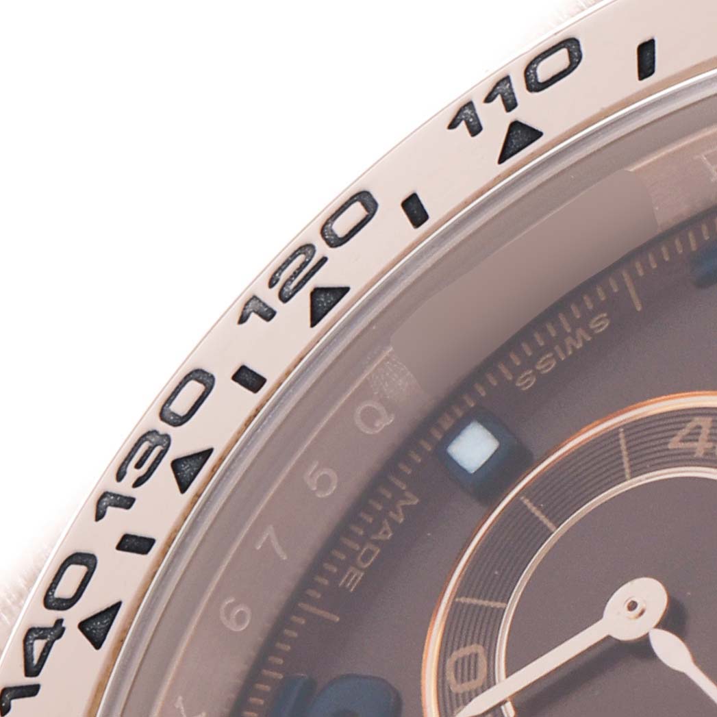 The image shows a close-up of a Rolex Daytona 116505 Men's Rose Gold Brown Dial watch's bezel and part of the dial at an angled view.