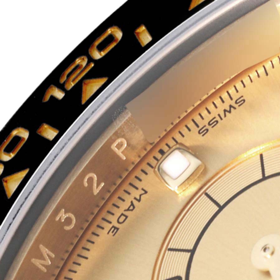 This close-up image of a Rolex Daytona 116518 Men's Yellow Gold Champagne Dial 116518 Men's Yellow Gold Champagne Dial watch shows part of the dial, bezel, and hour markers.