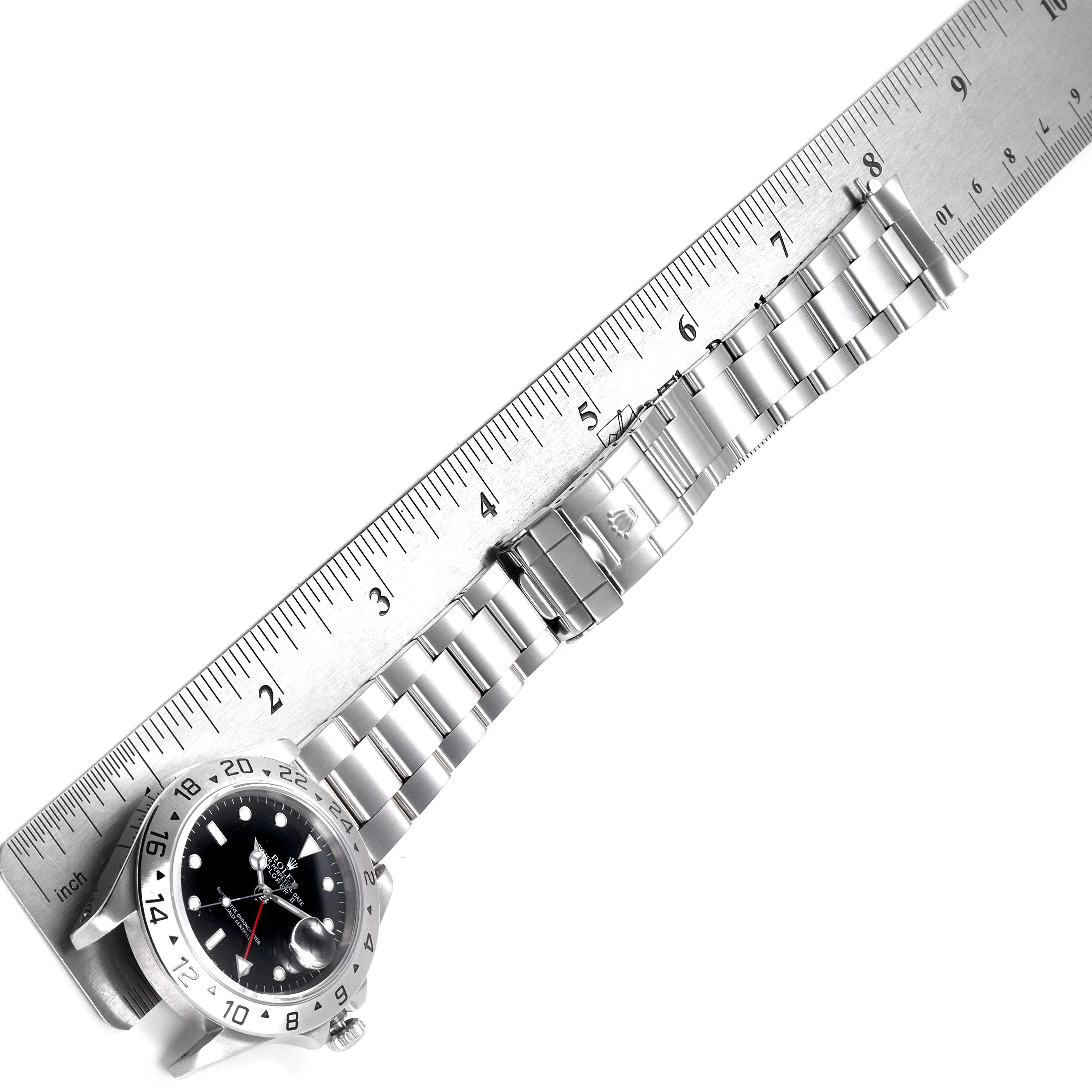 The Rolex Explorer 16570 Men's Stainless Steel Black Dial 16570 Men's Stainless Steel Black Dial watch is shown at an angle with its bracelet extended along a ruler for measurement.