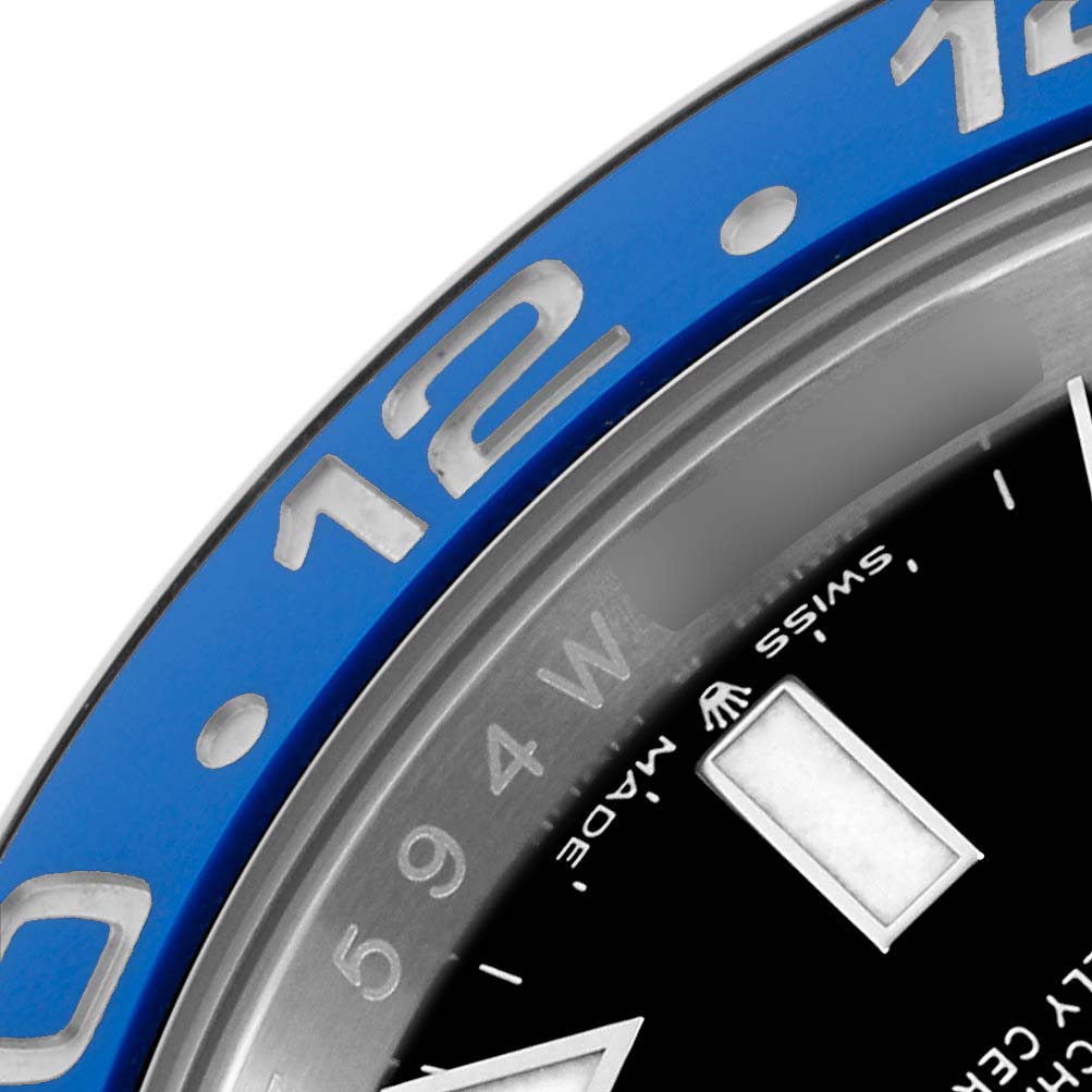 The image shows a close-up of the blue ceramic bezel and part of the dial of a Rolex GMT-Master 126710 Men
s Stainless Steel Black Dial.