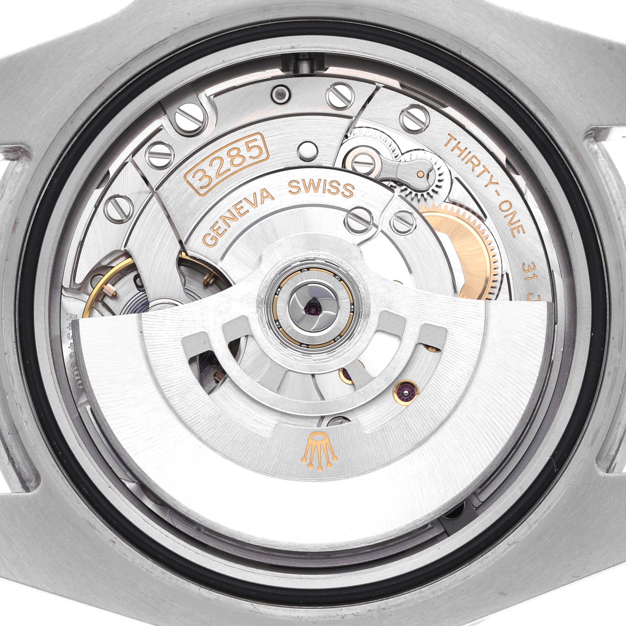 The image shows the movement of a Rolex GMT-Master 126710 Men
s Stainless Steel Black Dial watch from a top-down angle, highlighting the rotor and mechanical components.