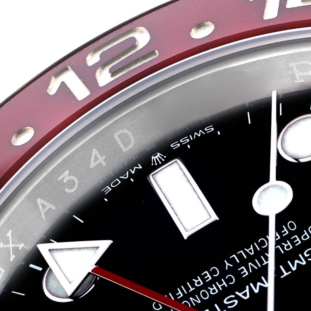 The image shows a close-up of the bezel and dial of a Rolex GMT-Master 126710 Men
s Stainless Steel Black Dial, focusing on the 12 o
clock position and hour markers.