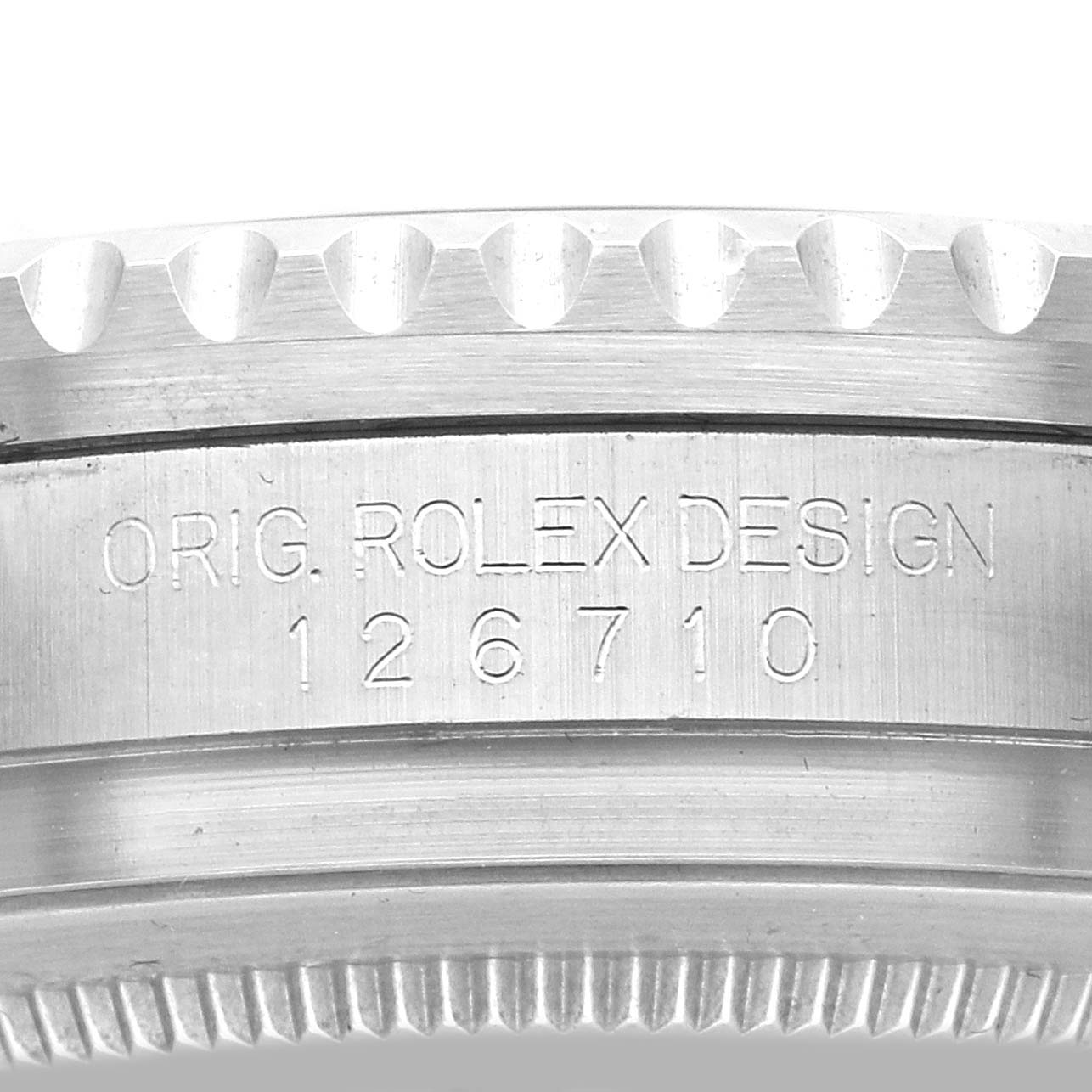 The image shows the side view of a Rolex GMT-Master 126710 Men
s Stainless Steel Black Dial model, focusing on the engraved case with text and reference number.