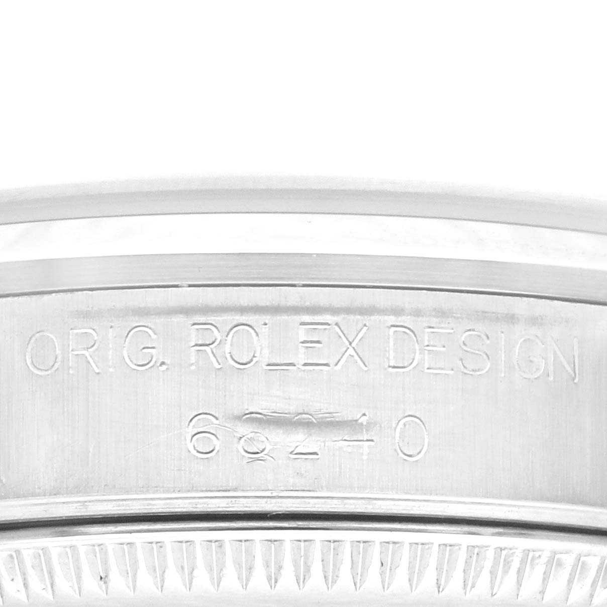 The image shows an up-close view of the side of a Rolex Mid-Size 68240 Women's Stainless Steel Black Dial 68240 Women's Stainless Steel Black Dial model watch, featuring the etched text "ORIG. ROLEX DESIGN" and the model number "68240".